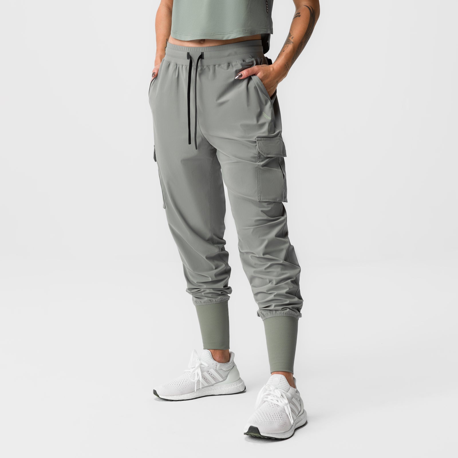 Sage Tetra-Lite cargo jogger worn by model, front view with hands in pockets