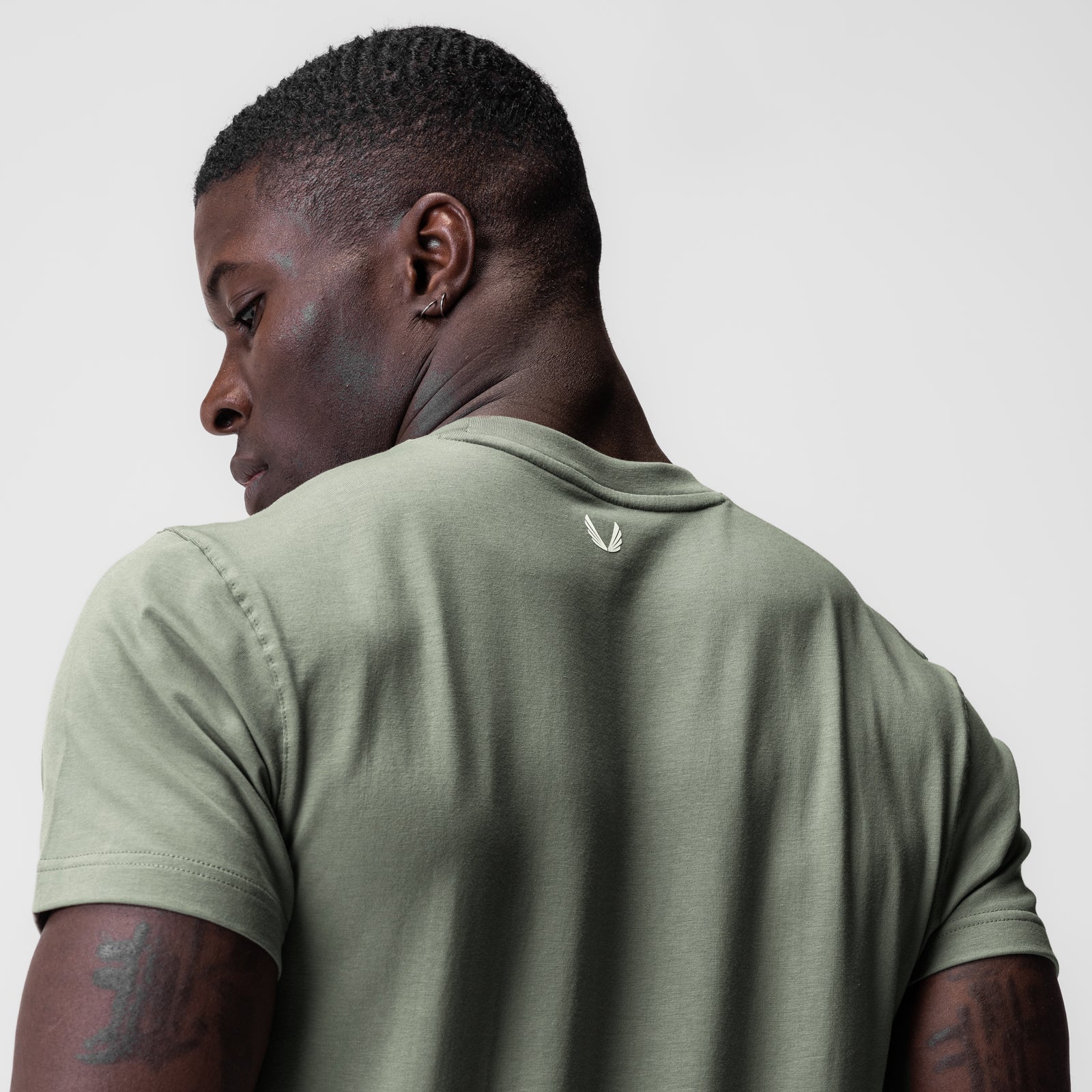 Supima Essential Tee in sage green worn by model, back view