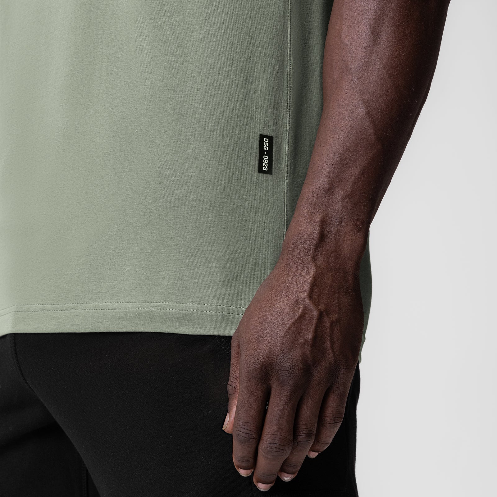 Supima Essential Tee in sage worn by model, side view detail