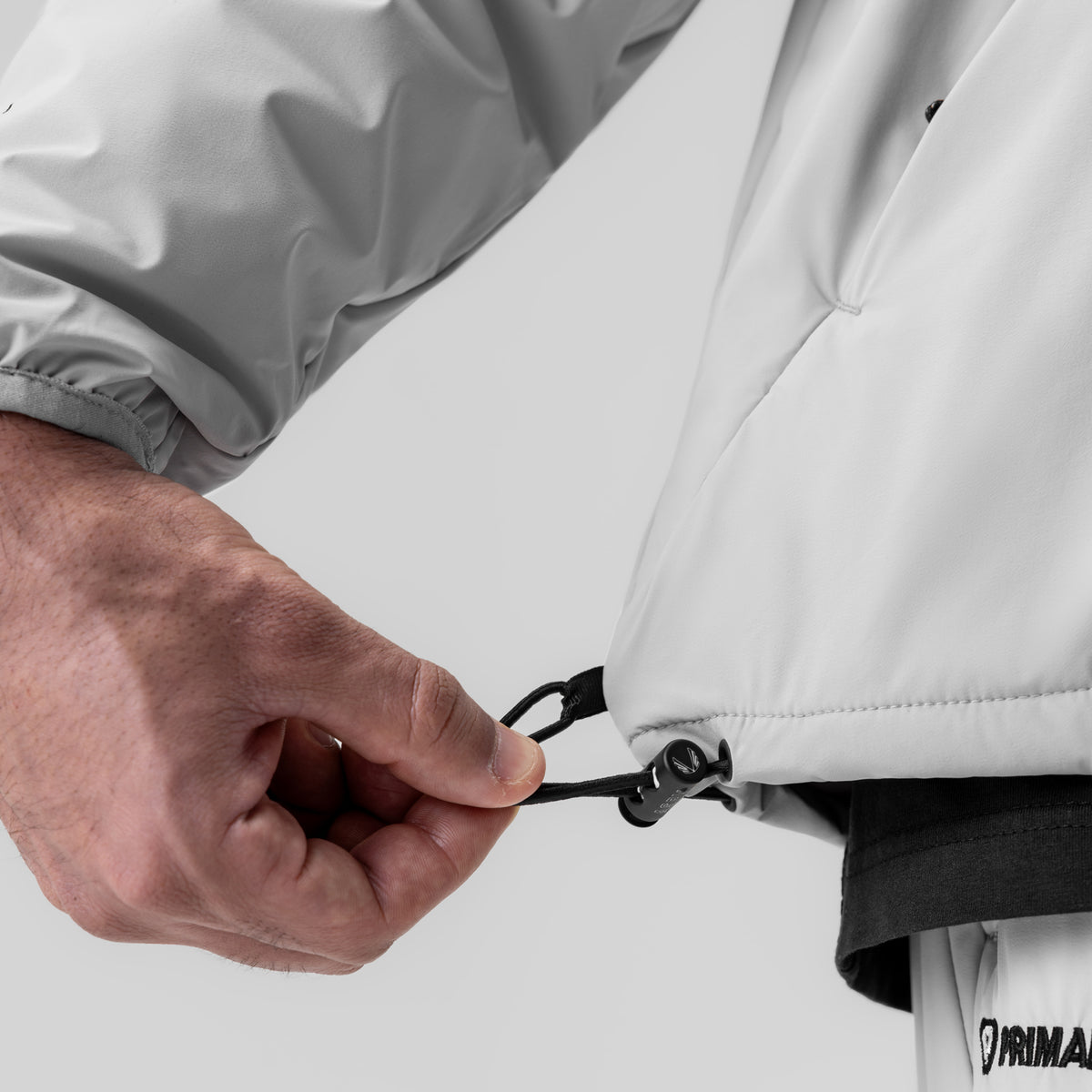 Aerotex PrimaLoft Quarter Zip in Slate Grey, detail shot of drawcord and zipper being held