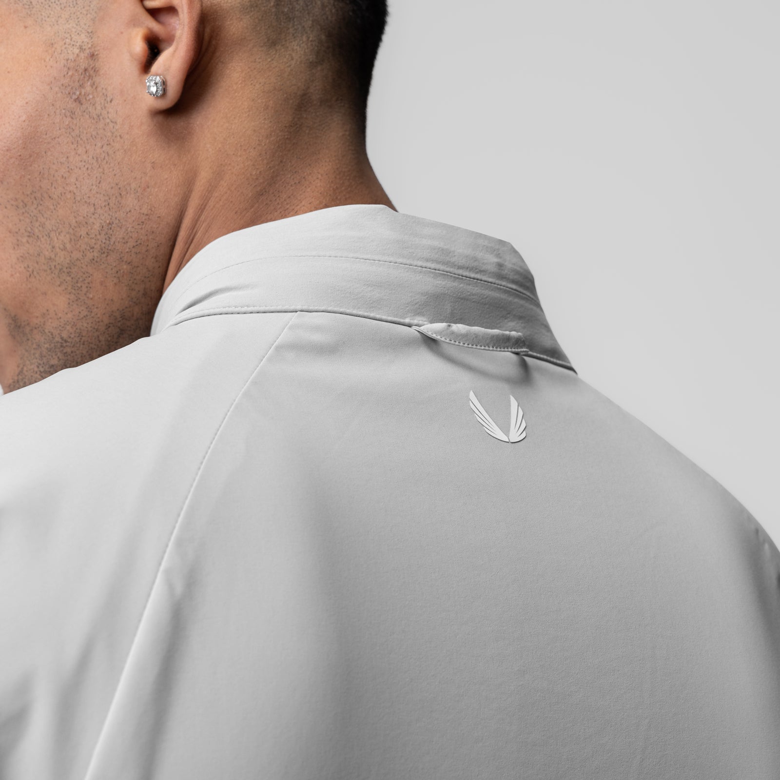 Aerotex Weather-Ready Bonded Windbreaker in slate grey, worn by model from back showing feather logo detail
