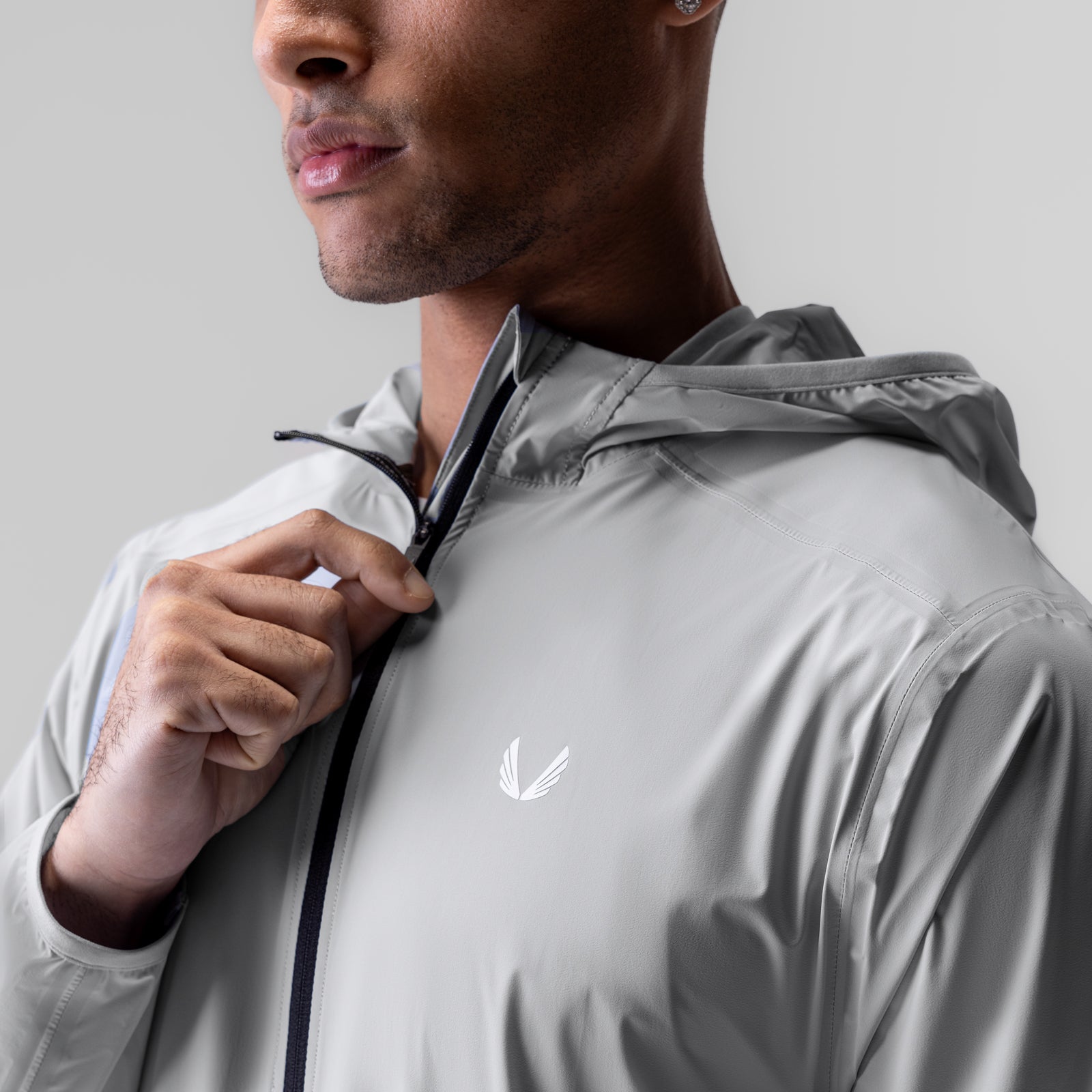 Aerotex™ Lightweight Windbreaker in slate grey, worn by model with hood over shoulder