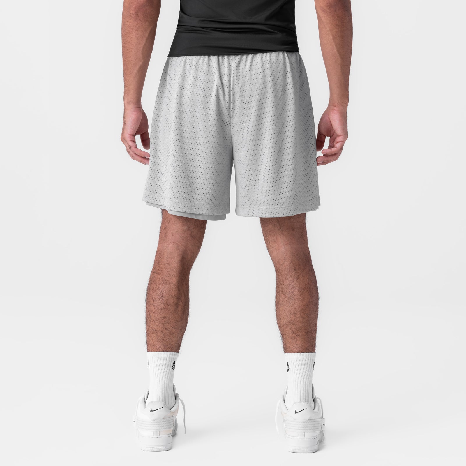 Reversible 2-in-1 shorts in slate grey worn by model, back view