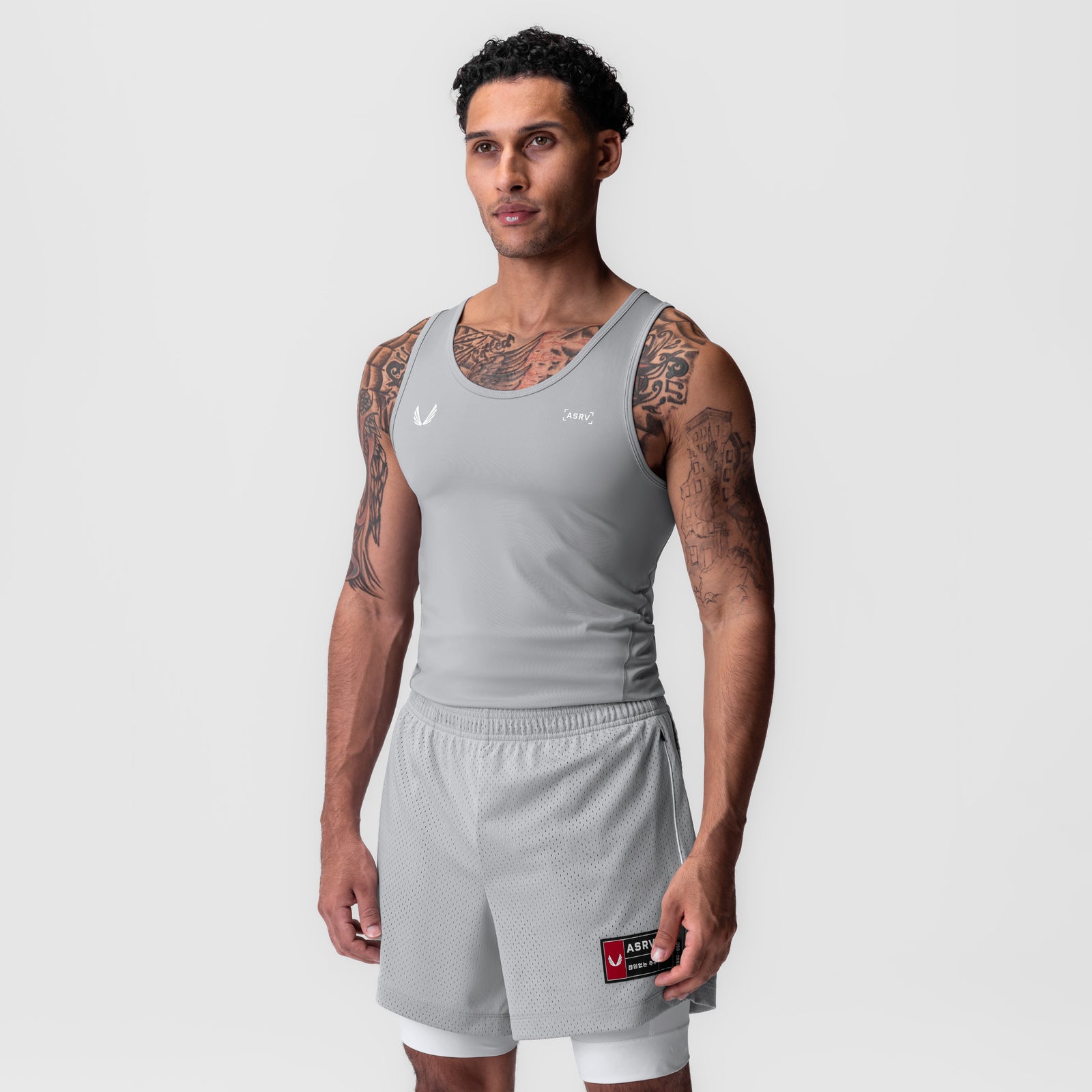 WarpFlexx-Lite Slim Tank in slate grey worn with shorts, front view on model
