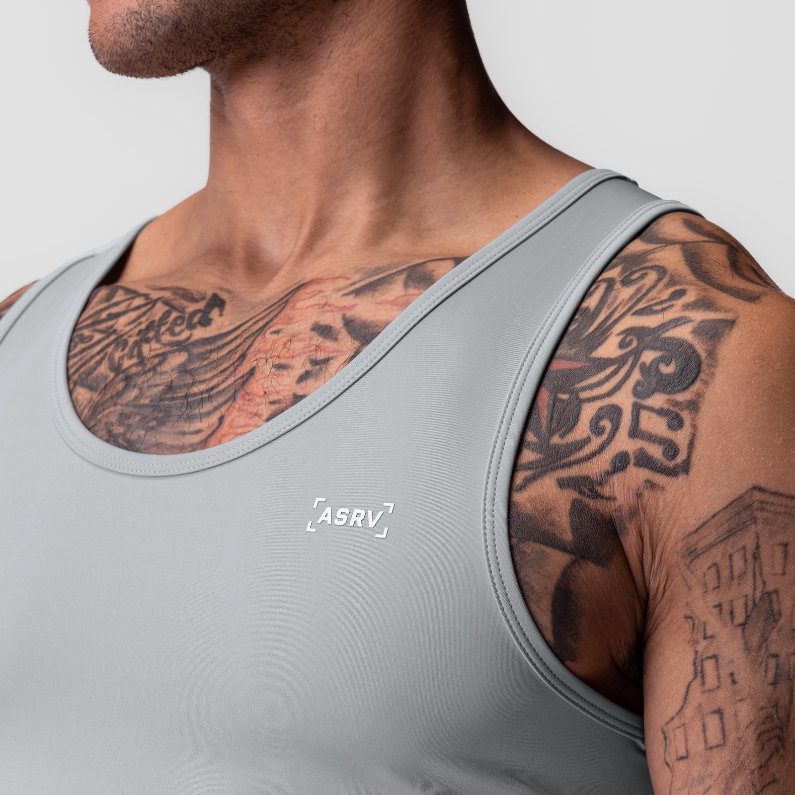WarpFlexx-Lite Slim Tank in slate grey worn by male model, side view