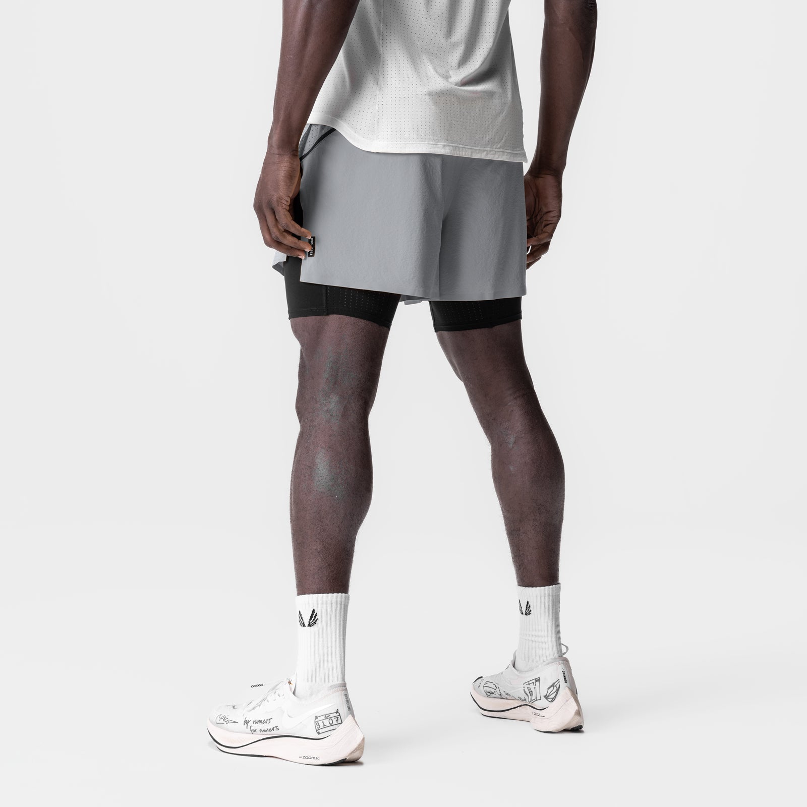 Aerotex 4" High Split Liner Short in slate grey with black liner shorts, worn with white socks and sneakers