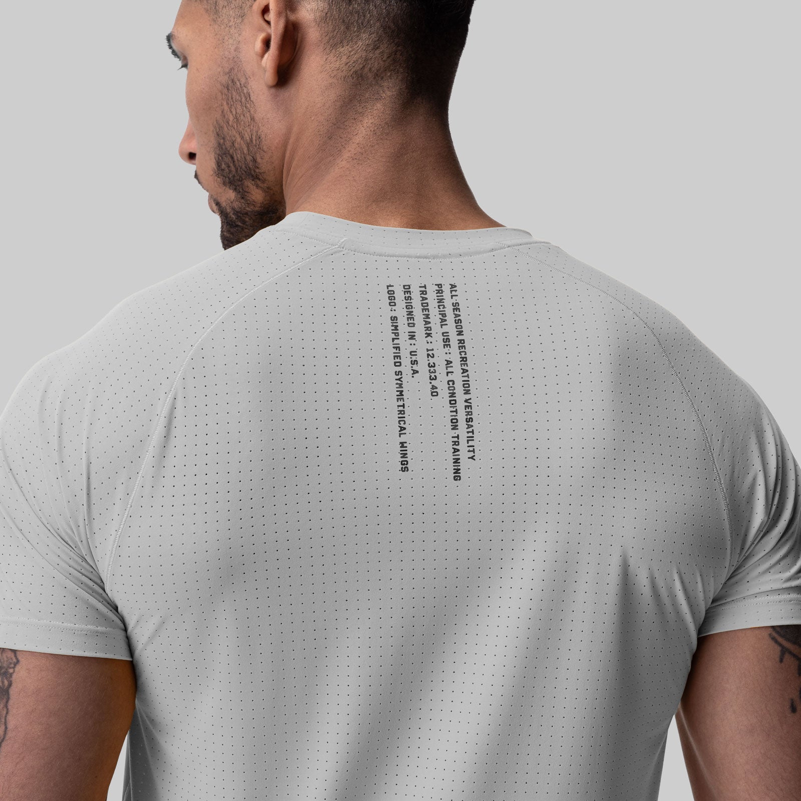 Laser-Vent Established Tee in slate grey worn by model, back view showing perforated fabric