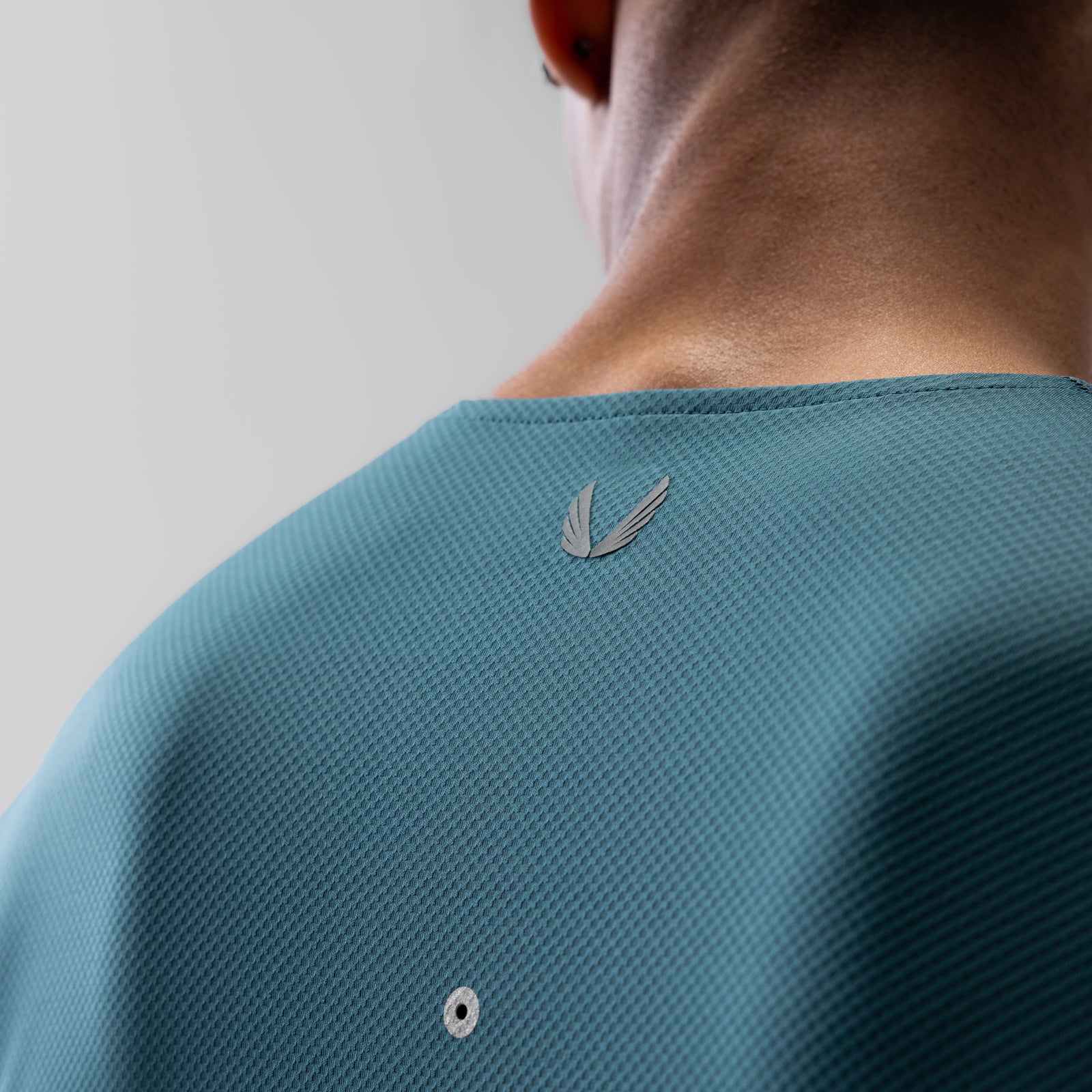 AeroSilver Training Long Sleeve in storm blue worn by model, back view showing logo detail