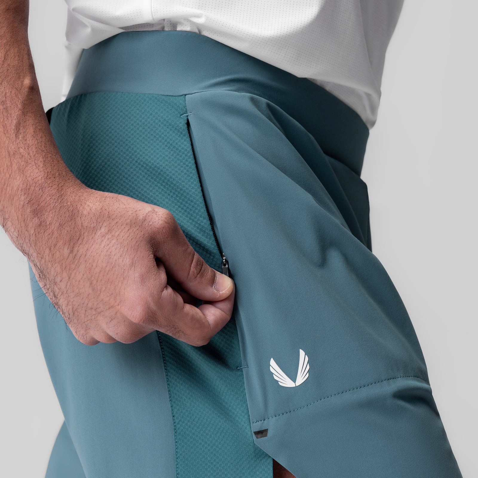 Tetra-Lite Bonded Training Short in storm blue, worn by model with hand in pocket