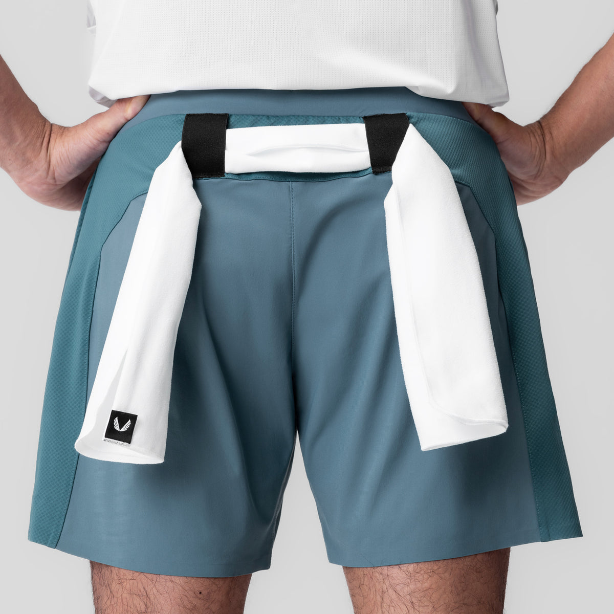 Tetra-Lite Bonded Training Short in storm blue, worn with white towel draped over shoulder