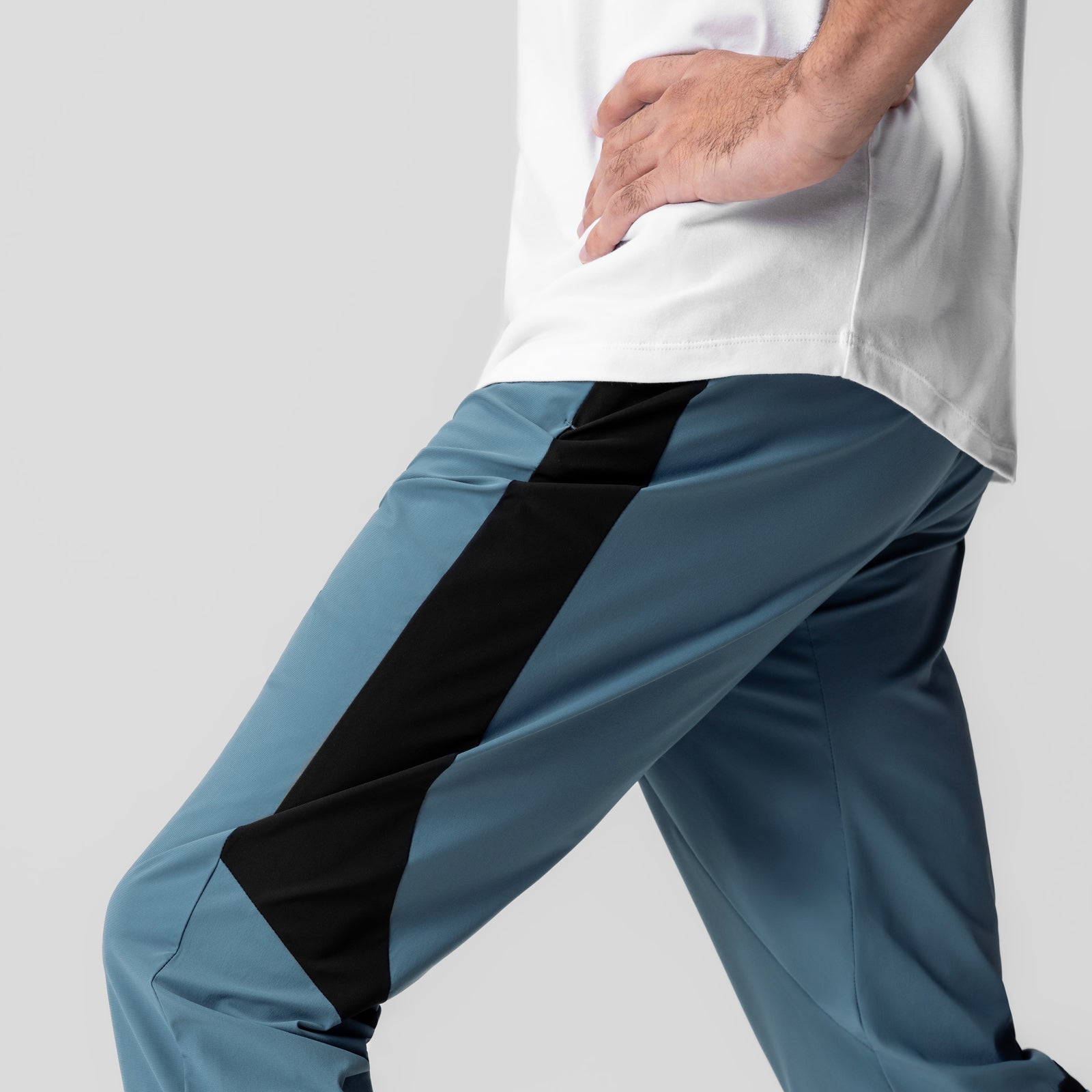 Tetra-Lite Cuffed Training Jogger in storm blue with black stripe, worn by model