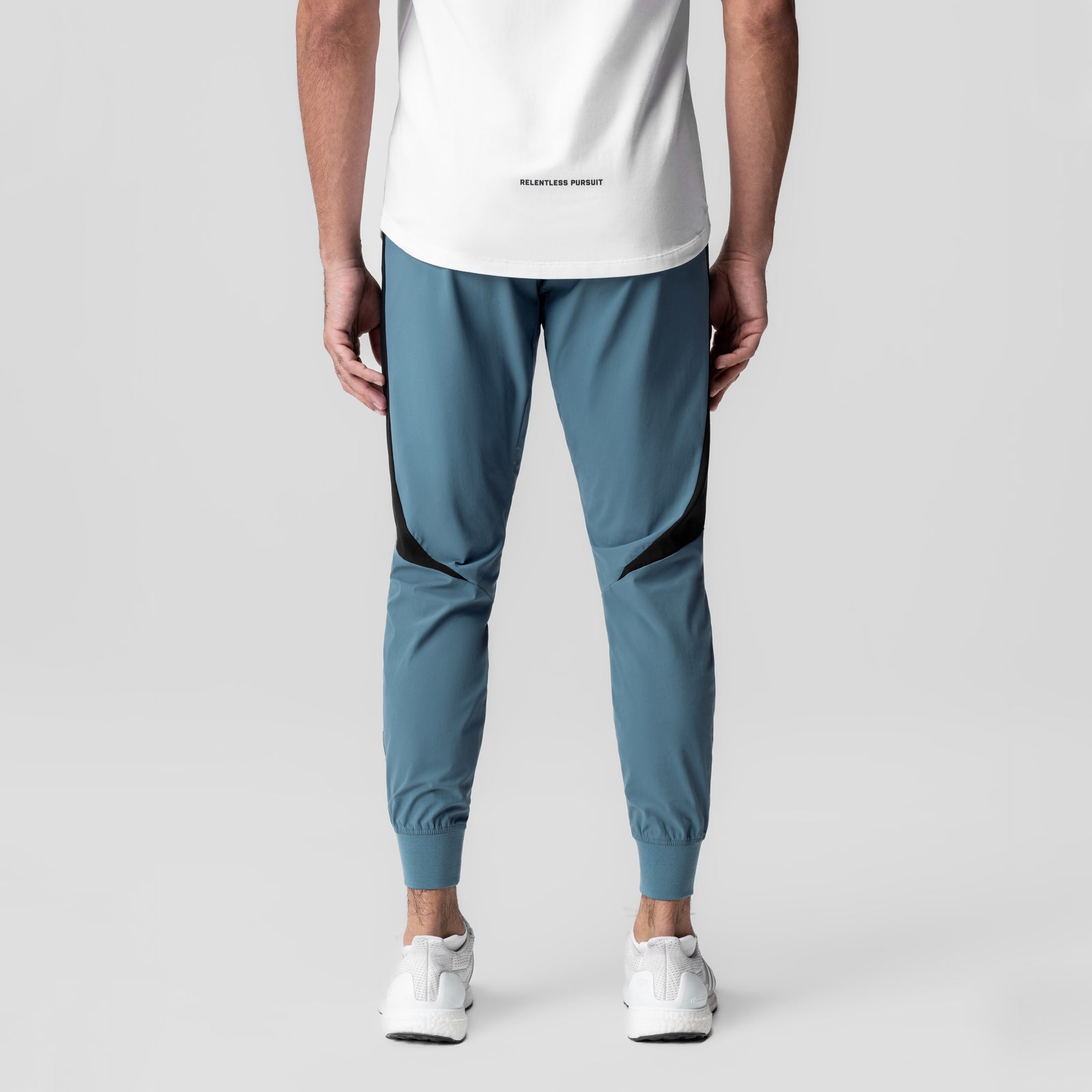 Tetra-Lite® Cuffed Training Jogger in storm blue with black paneling, back view on model
