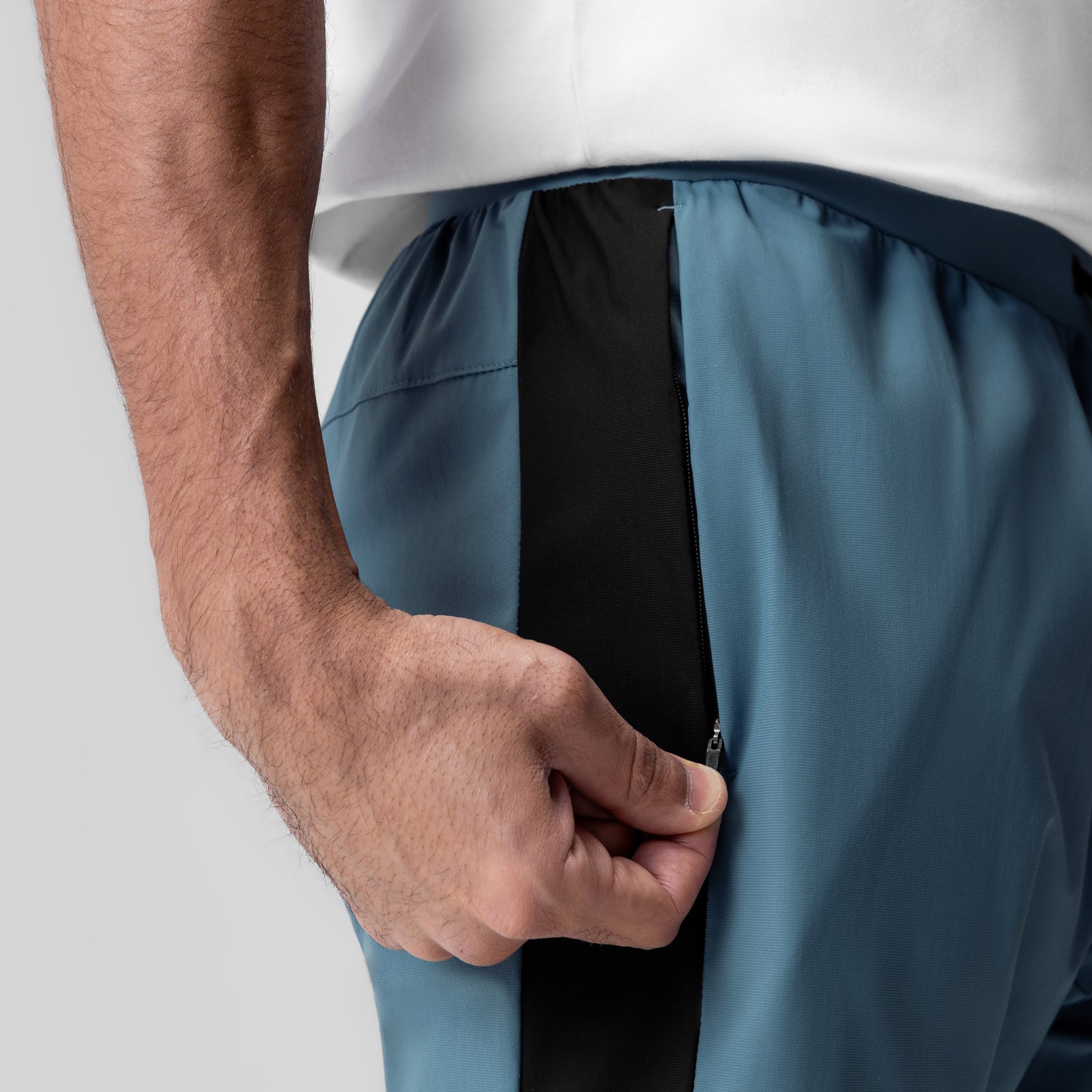 Tetra-Lite Cuffed Training Jogger in storm blue, worn by model showing side pocket detail