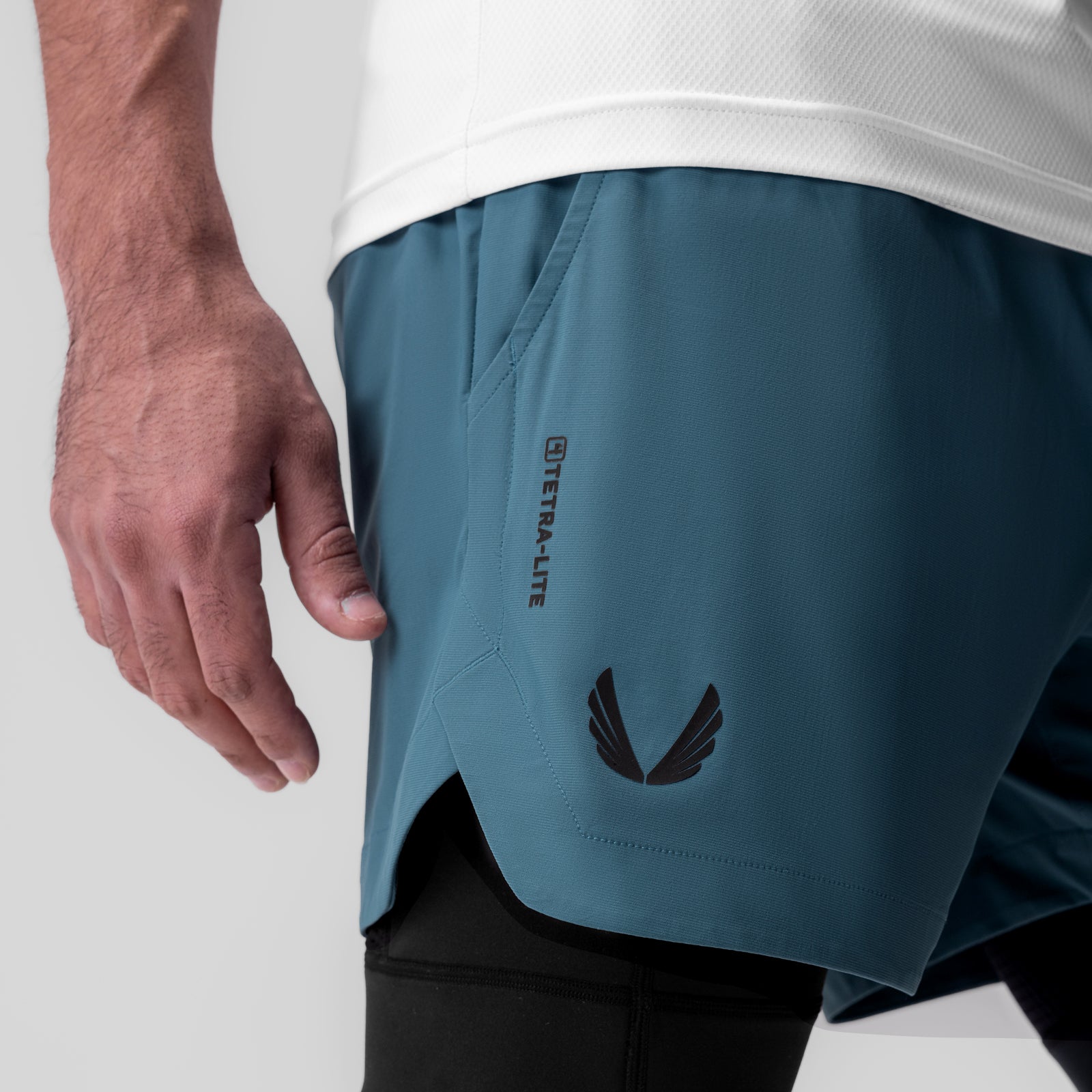 Tetra-Lite 5" Liner Short in Storm blue with black wings logo, worn by model
