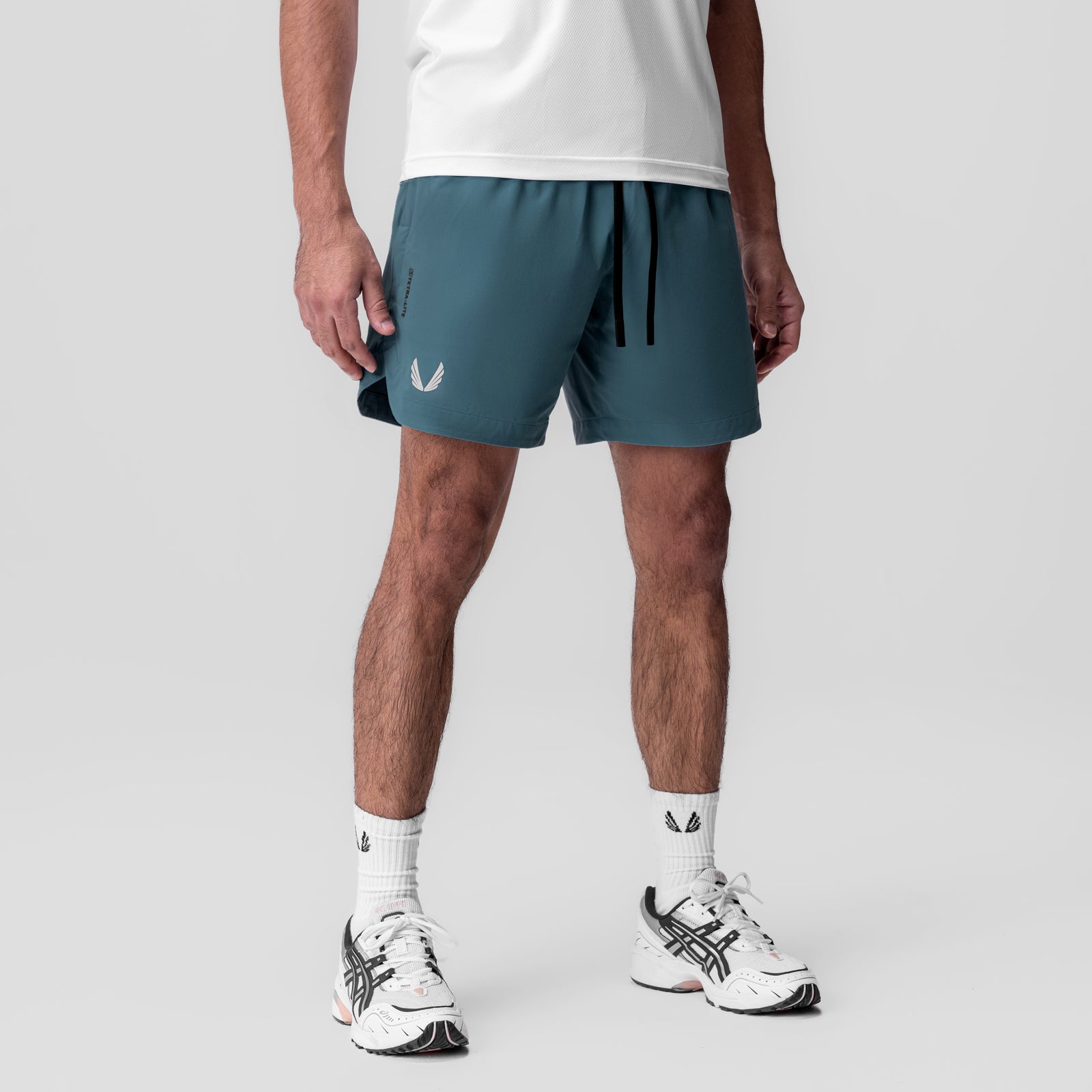 Tetra-Lite 7" Linerless Short in storm blue with Wings logo, worn with white socks and sneakers