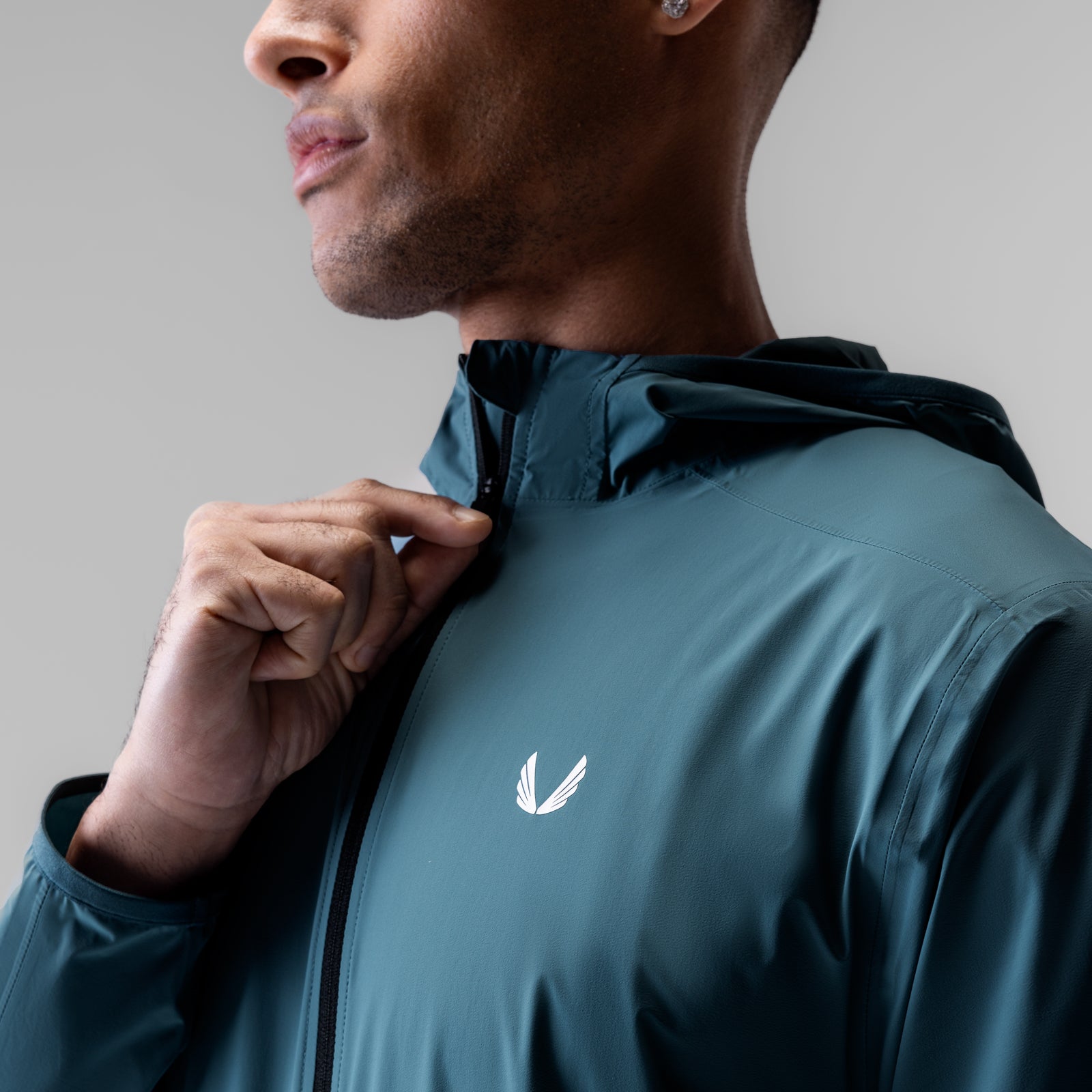 Aerotex Lightweight Windbreaker in storm blue, worn by model from side angle