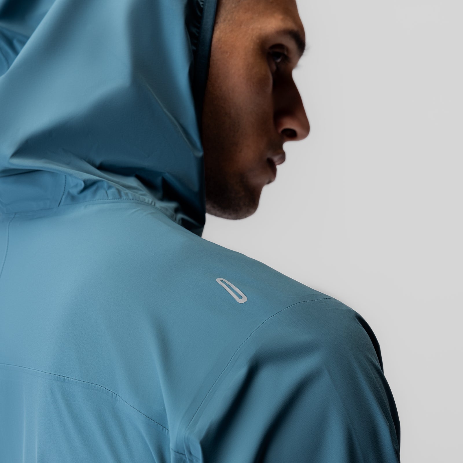 Aerotex Lightweight Windbreaker in storm blue, worn by model in profile view