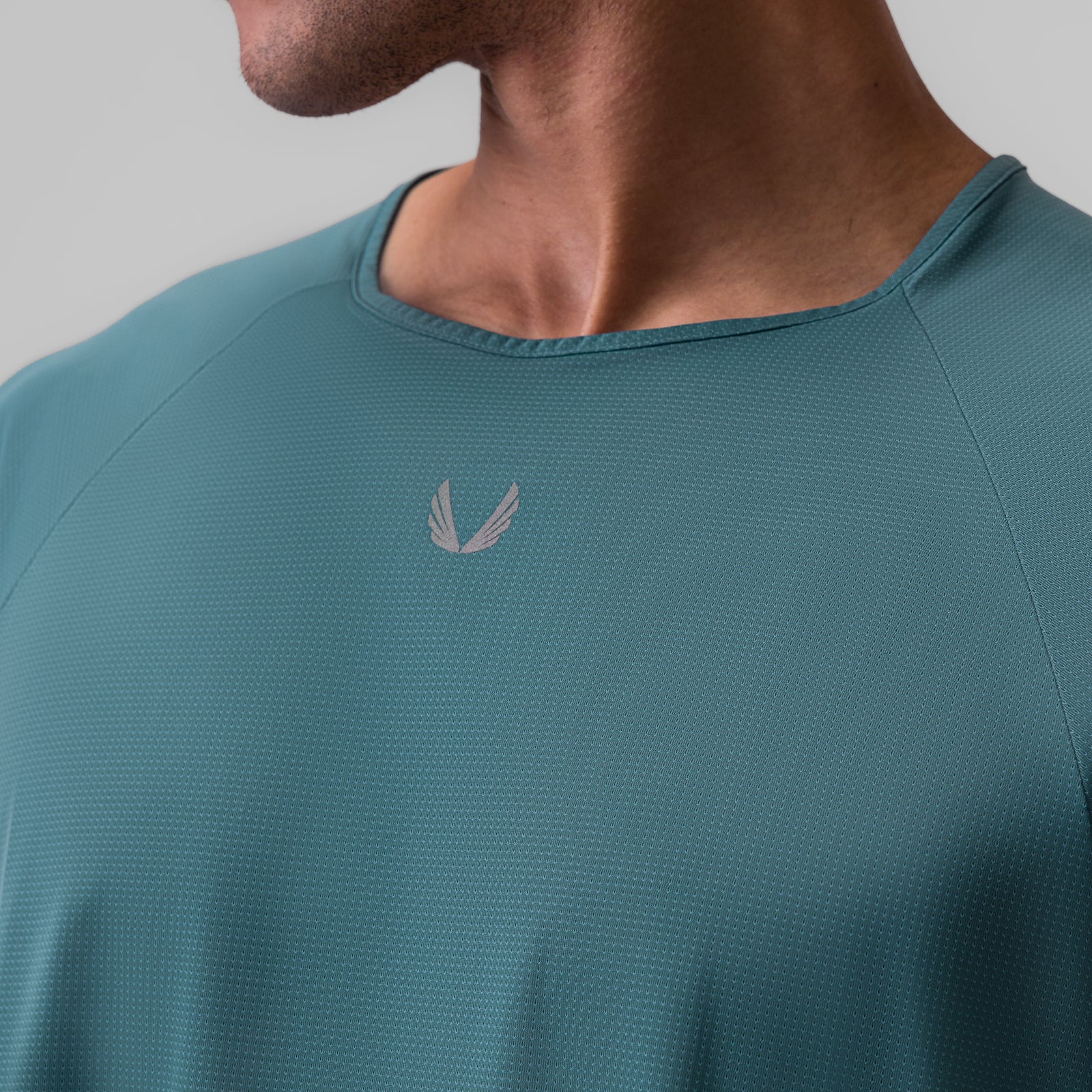 Ice-Skin™ Oversized Tee in storm blue worn by model, chest detail view