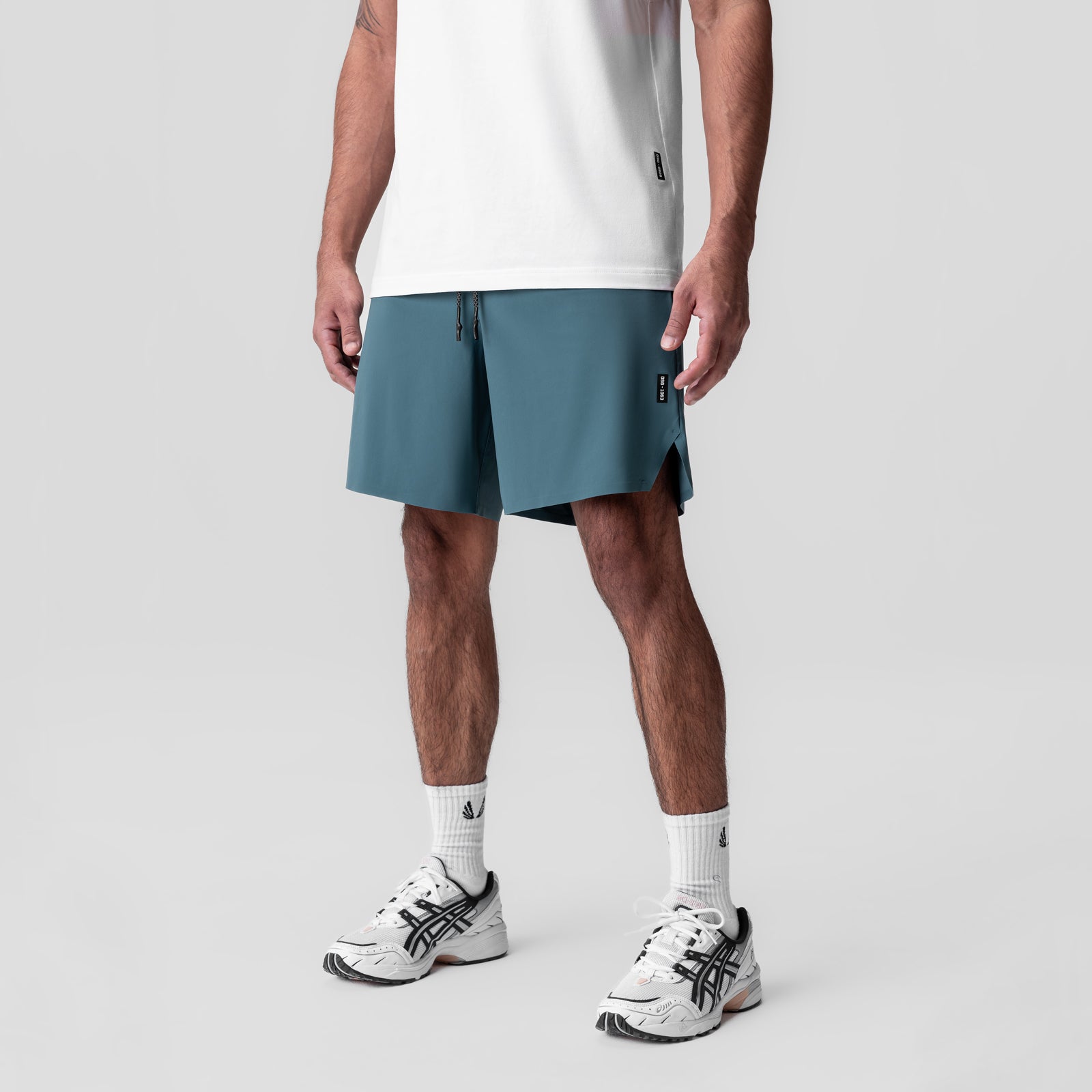Revolutional Field Short in storm blue, worn with white tee and sneakers, front view