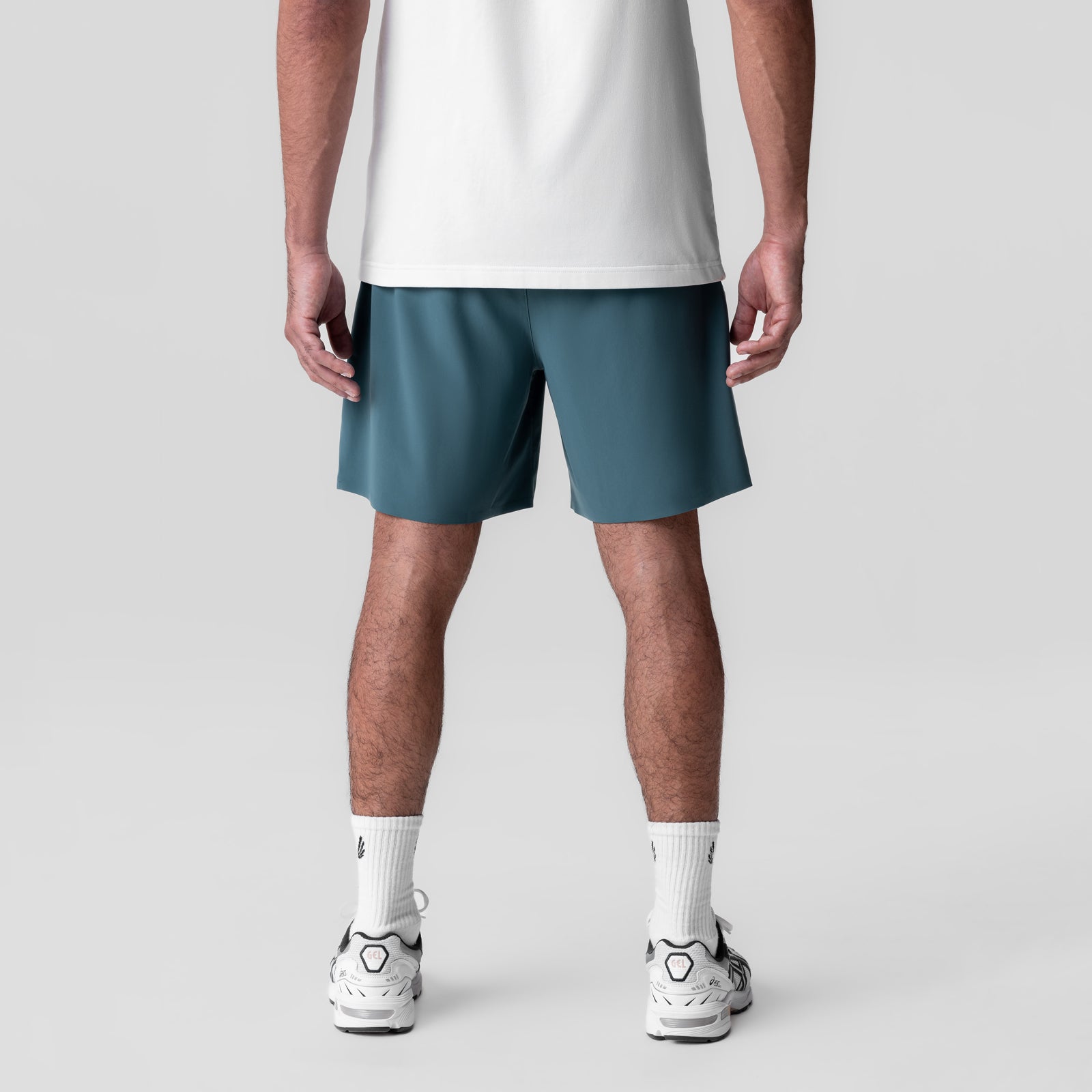 Revolutional Field Short in storm blue, back view on model wearing white tee and white sneakers