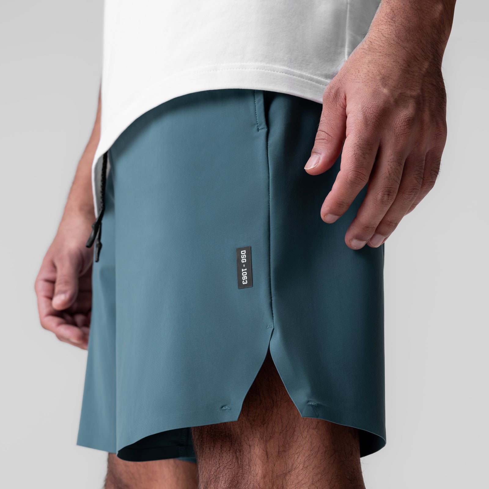 Revolutional Field Short in storm blue, worn by model showing side view and fit
