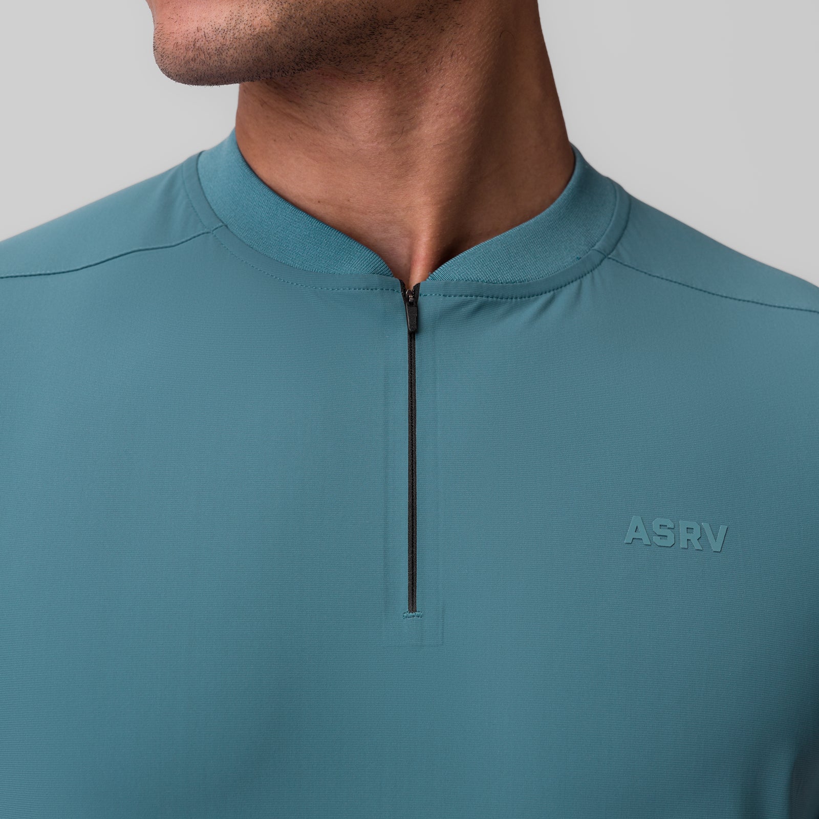 Tetra-Lite Ice Zip Tee in storm blue worn by model, front neckline detail