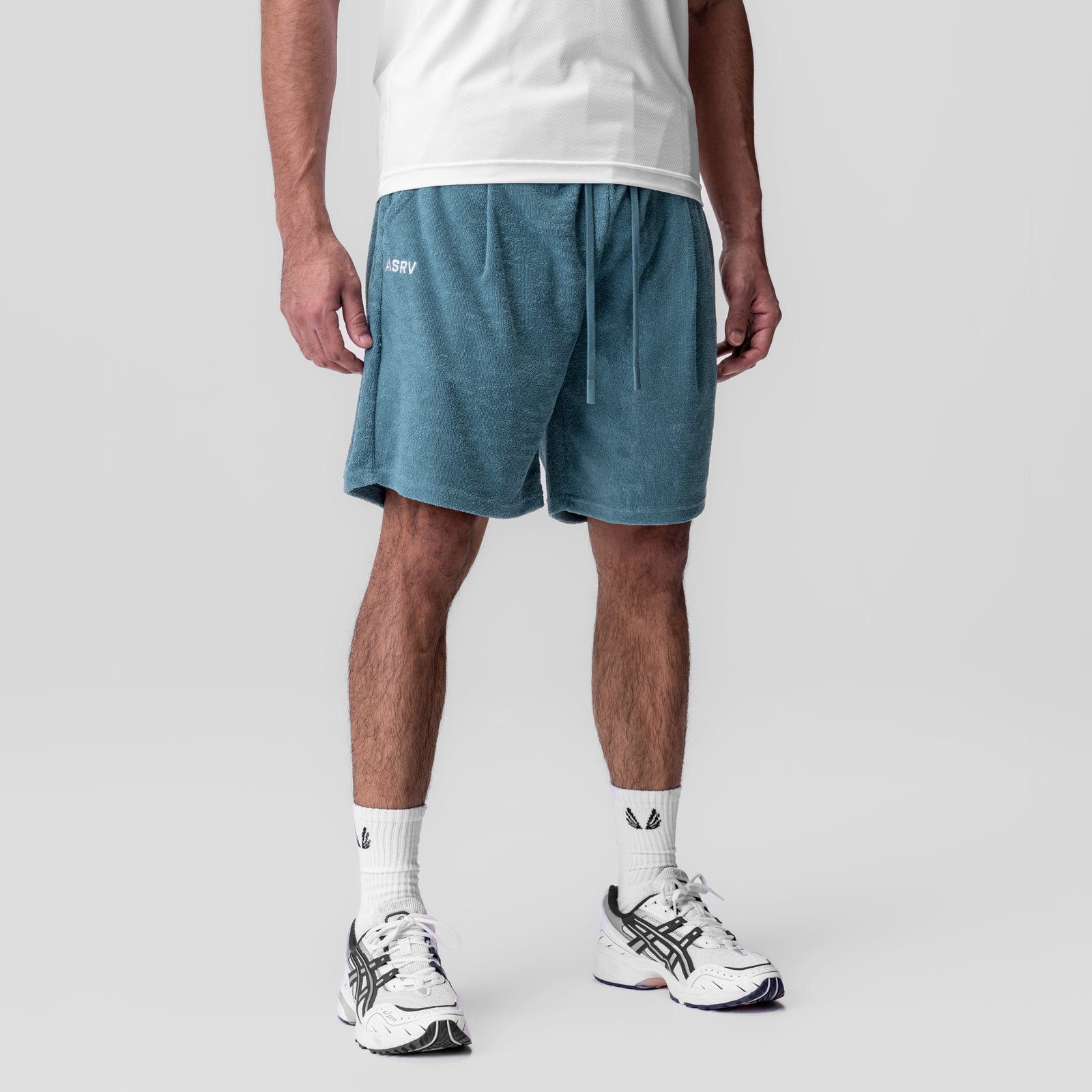 Towel Terry Relaxed Short in storm blue worn by model with white socks and sneakers, front view