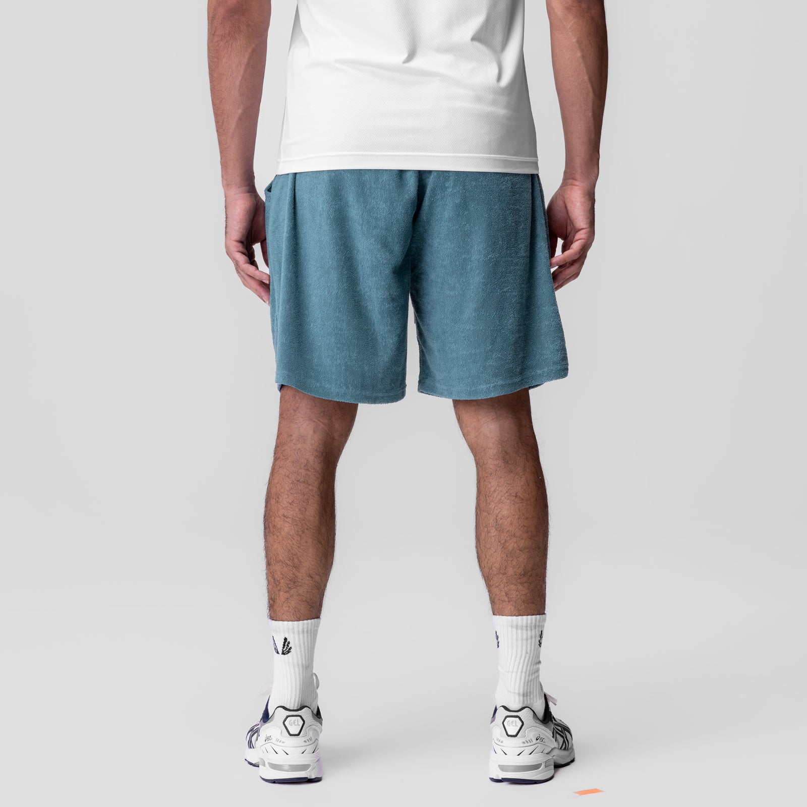 Towel Terry Relaxed Short in storm blue, worn by model from behind with white sneakers