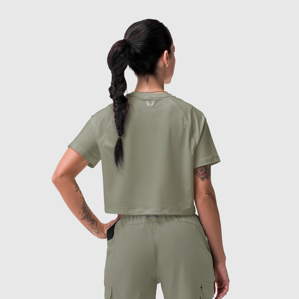 AeroSilver Cropped Tee in sage worn by model from back, paired with matching cargo pants