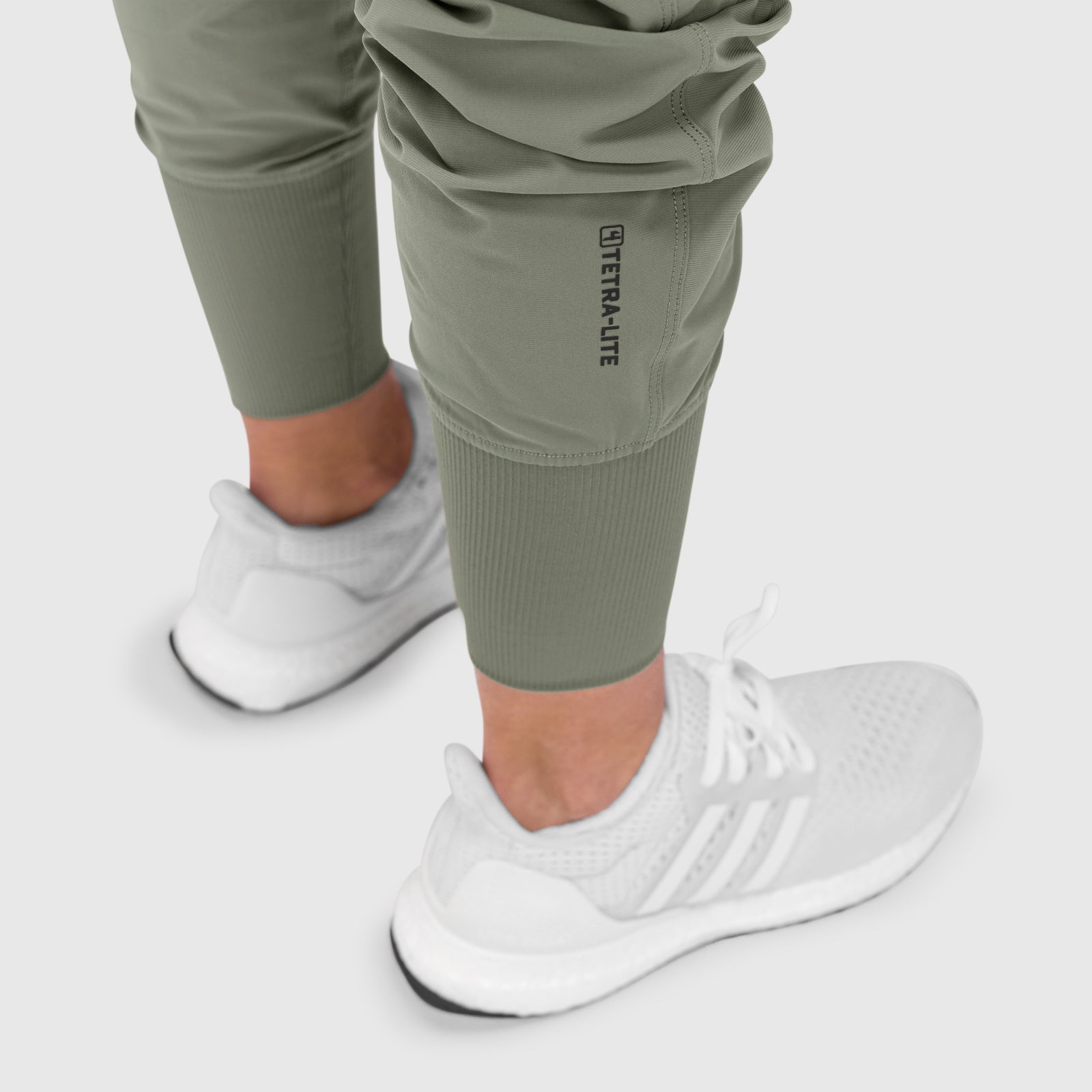Tetra-Lite Cargo High Rib Jogger in sage, worn with white sneakers and socks, front view