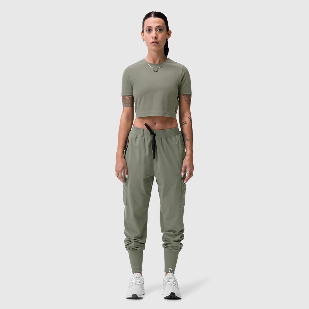 Sage green cropped tee worn with matching cargo joggers, front view on model