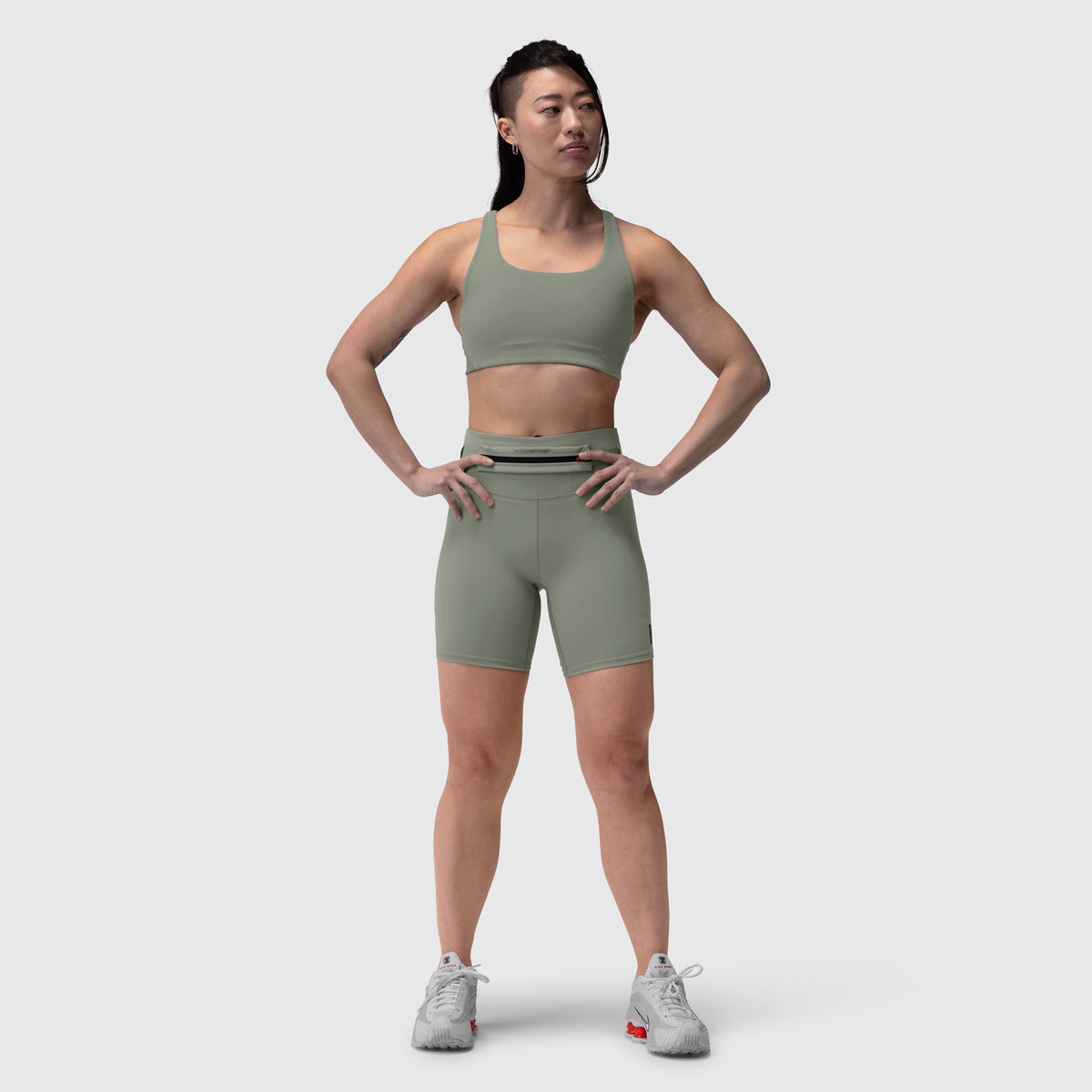 Lycra 3-in-1 biker short in sage, worn by model standing against white background
