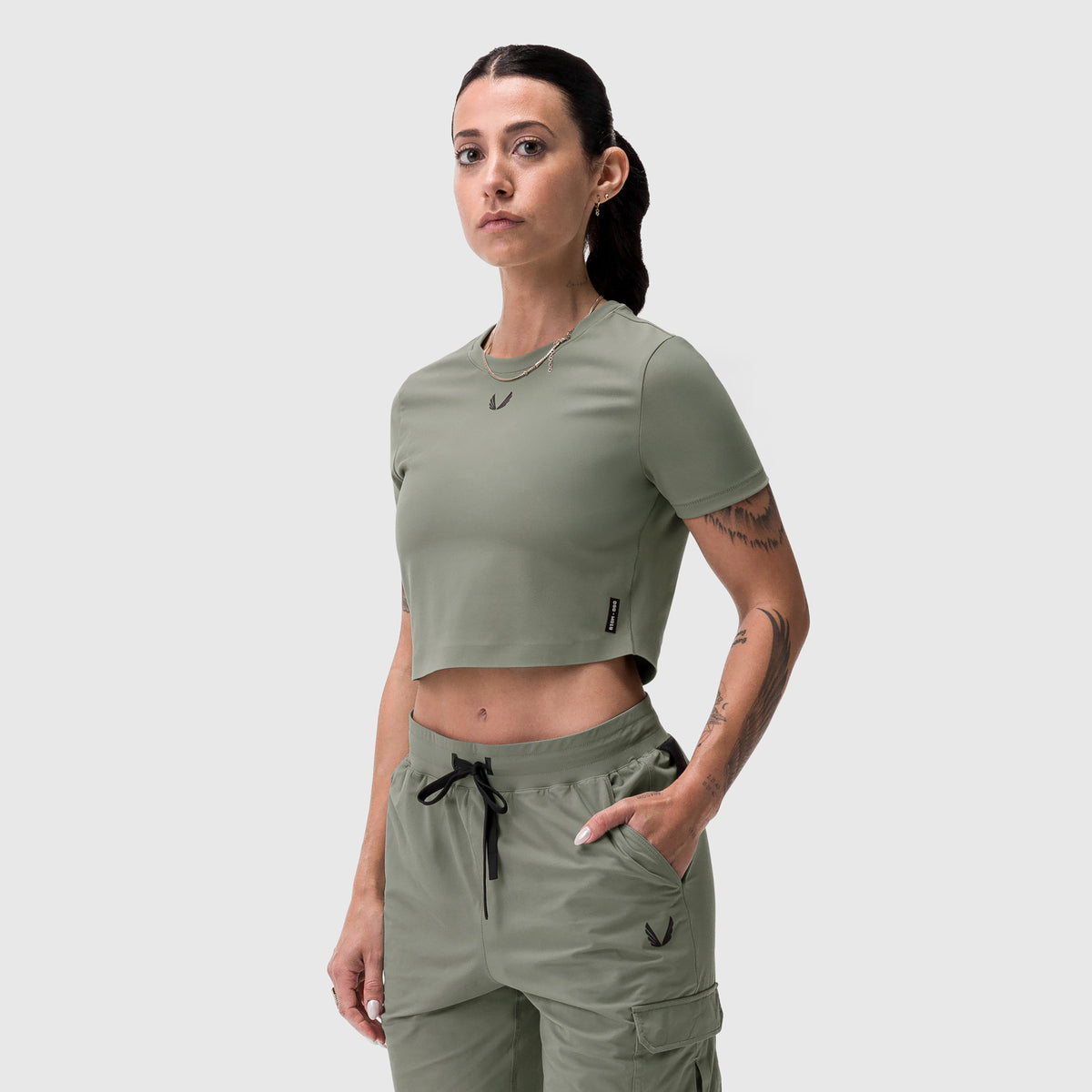Sage cropped tee worn by model, front view, paired with matching cargo pants