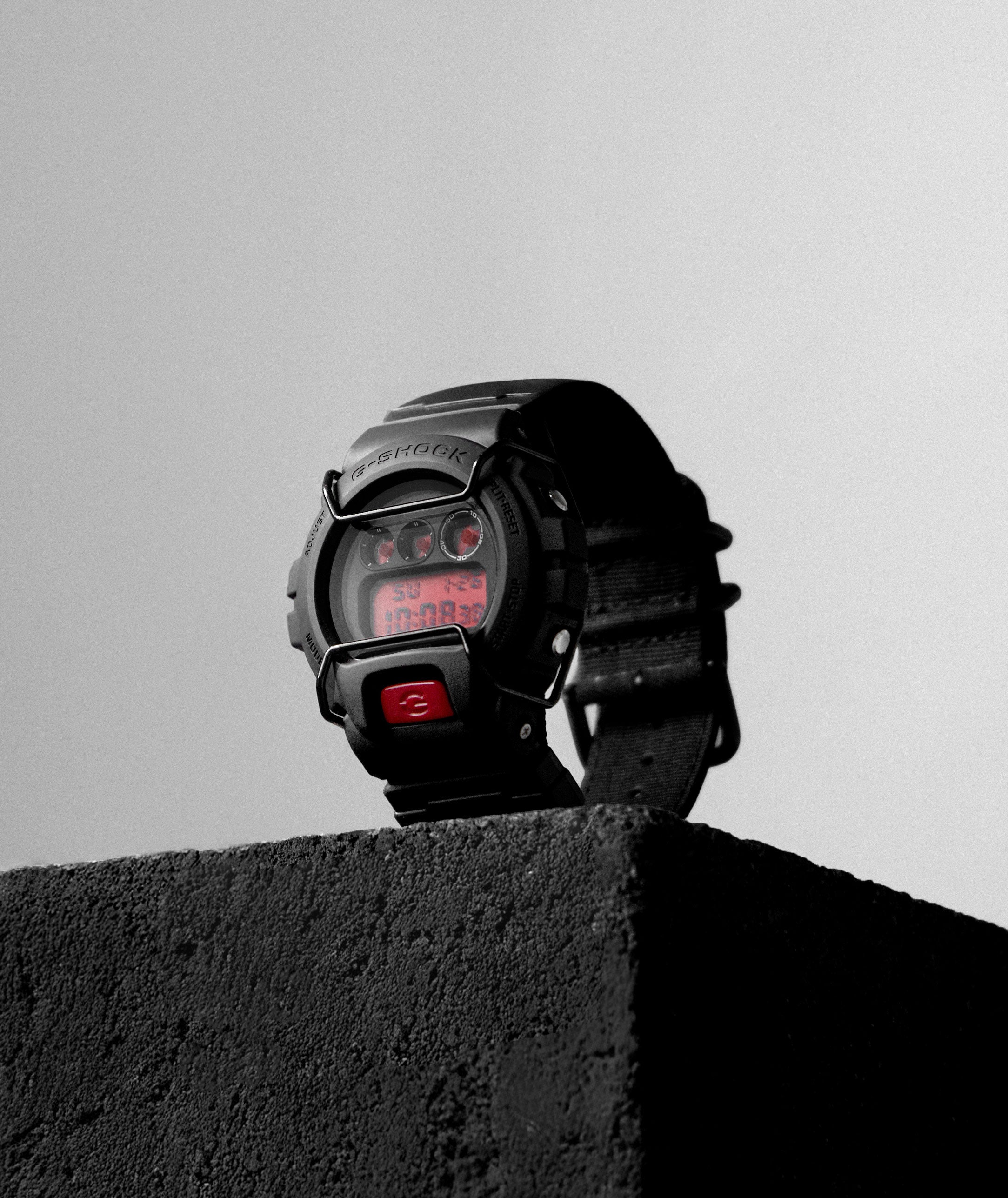 ASRV x G-SHOCK DW6900 digital watch in black worn on wrist, front view