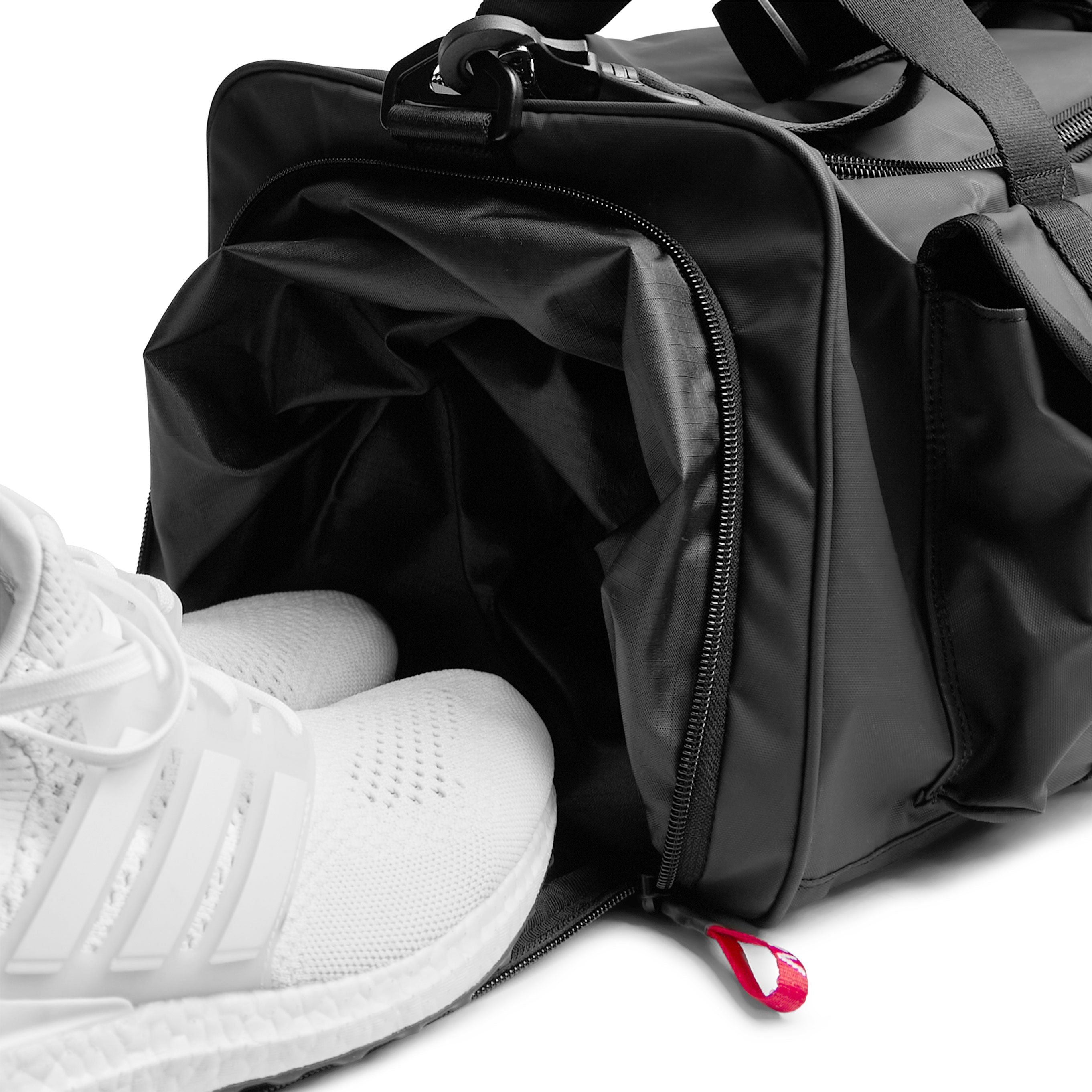 0710 Utility Gym Duffle Bag in Black, worn with white sneakers
