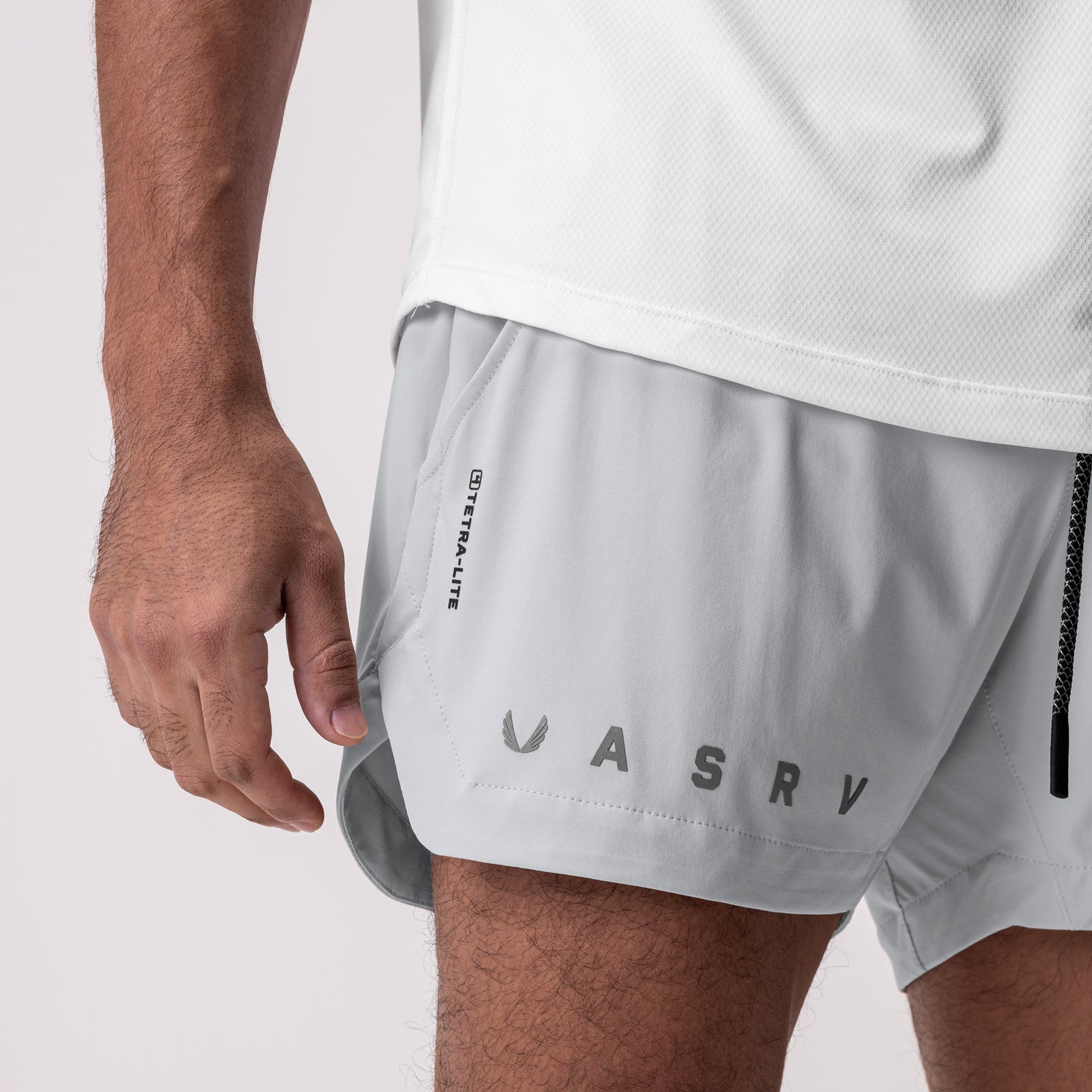 Tetra-Lite 5" Linerless Short in white, worn by model showing side view with branding