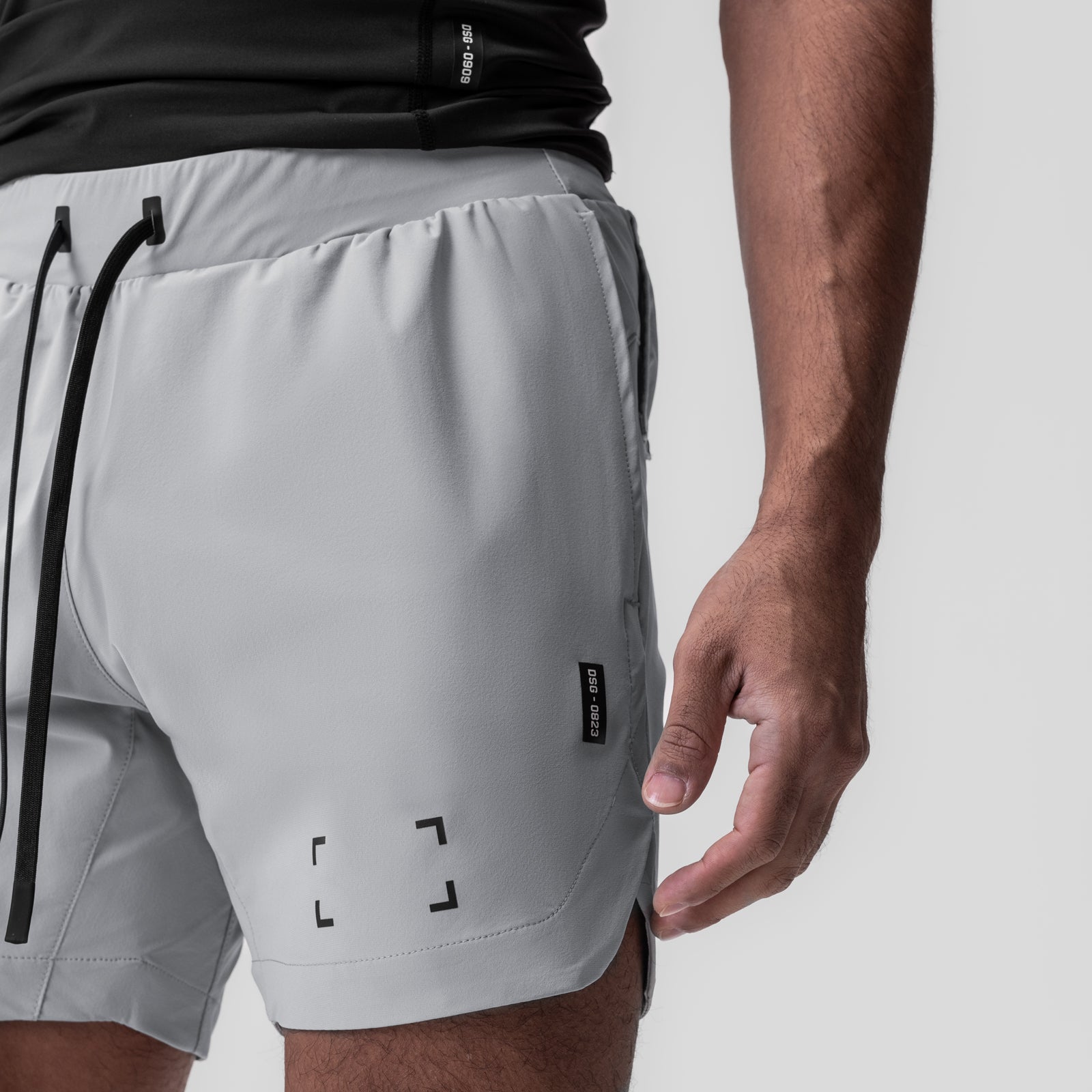 Tetra-Lite 7" Linerless Short in slate grey with space bracket design, worn by model, side view