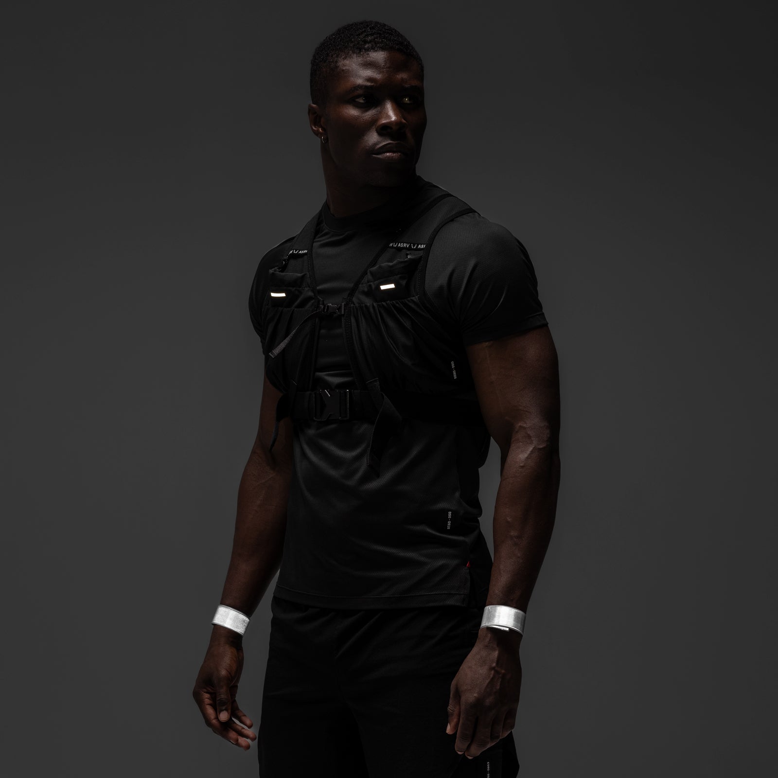 Black ASRV x Bookman Reflective Snap Band vest worn by male model, front view
