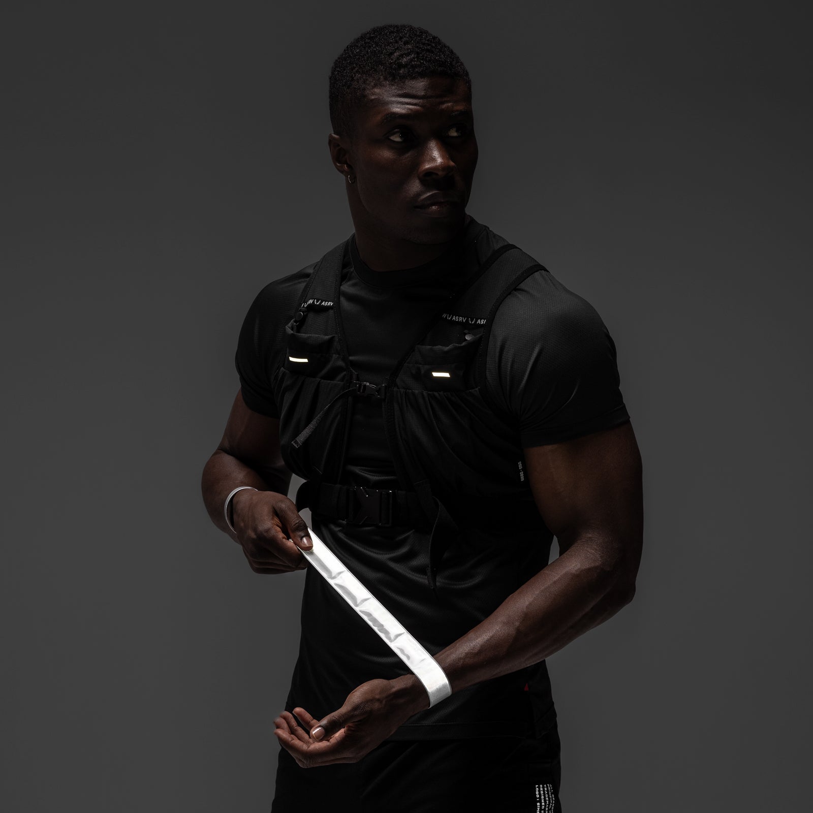 ASRV x Bookman Reflective Snap Band in white, worn and held by model