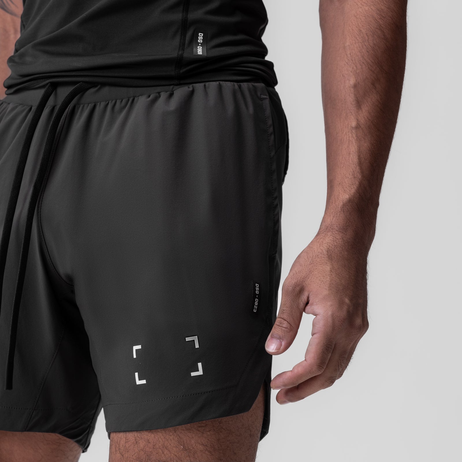 Tetra-Lite 7" Linerless Short in space grey with bracket logo, worn by model, side view
