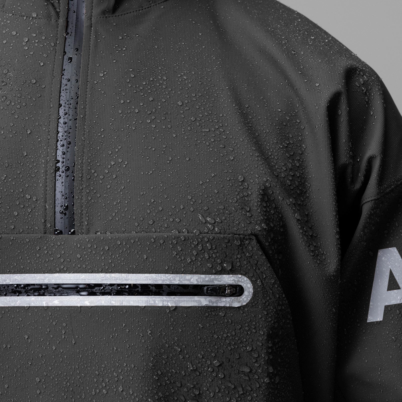 Weather-Ready Anorak Jacket in Space Grey, worn with water beads on fabric, detail shot