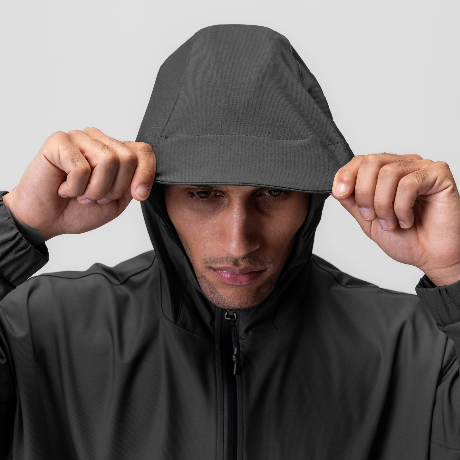 Weather-Ready Anorak Jacket in space grey worn by model pulling hood down, front view
