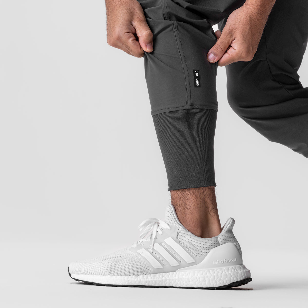Tetra-Lite Tech High Rib Jogger in Space Grey, worn with white sneakers, side view