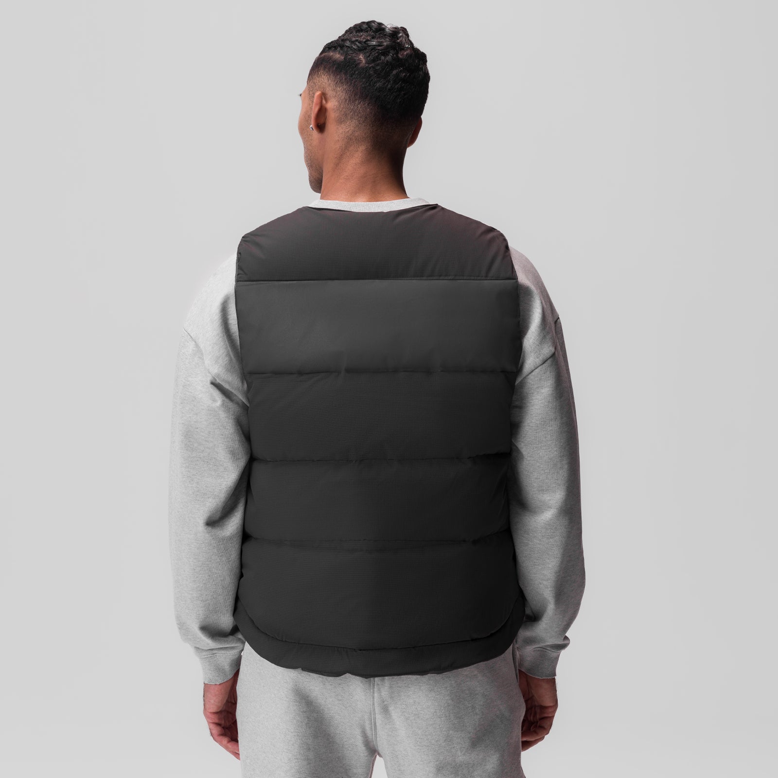 Ripstop Insulated Puffer Gilet in black, worn with grey sweatshirt, back view