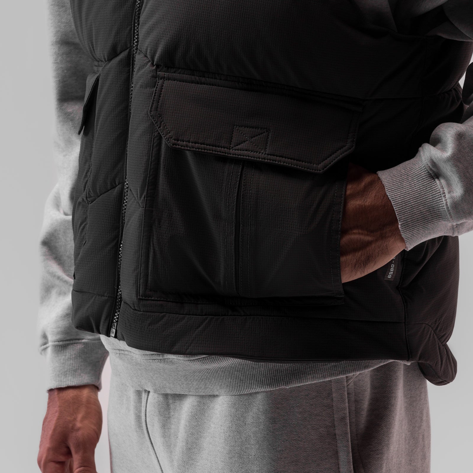 Ripstop Insulated Puffer Gilet in black worn over grey hoodie, side detail view