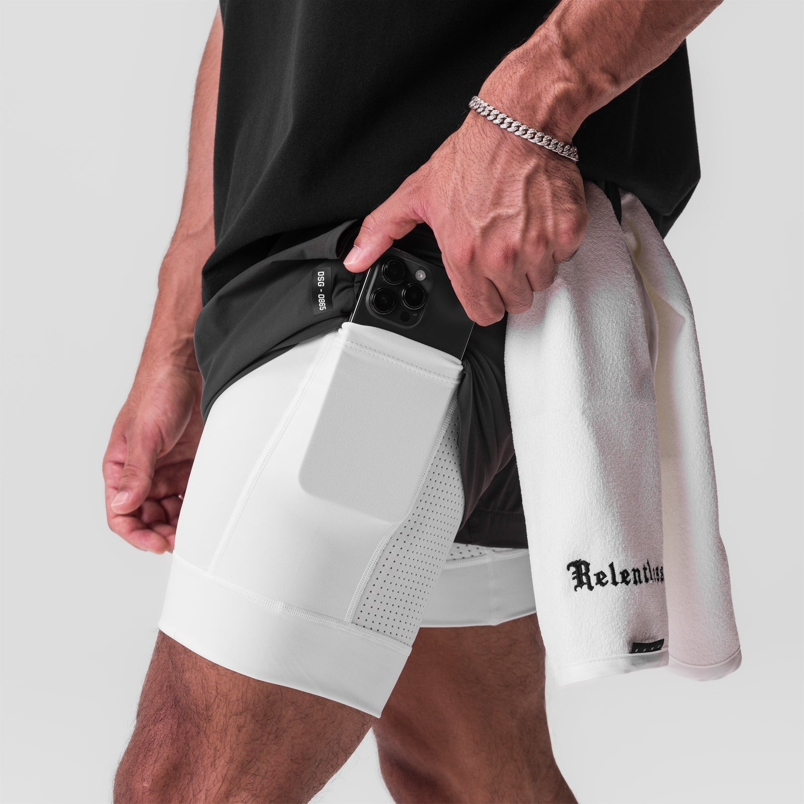 Tetra-Lite 5" Liner Short in Space Grey/White, model holding shorts at waist showing built-in liner