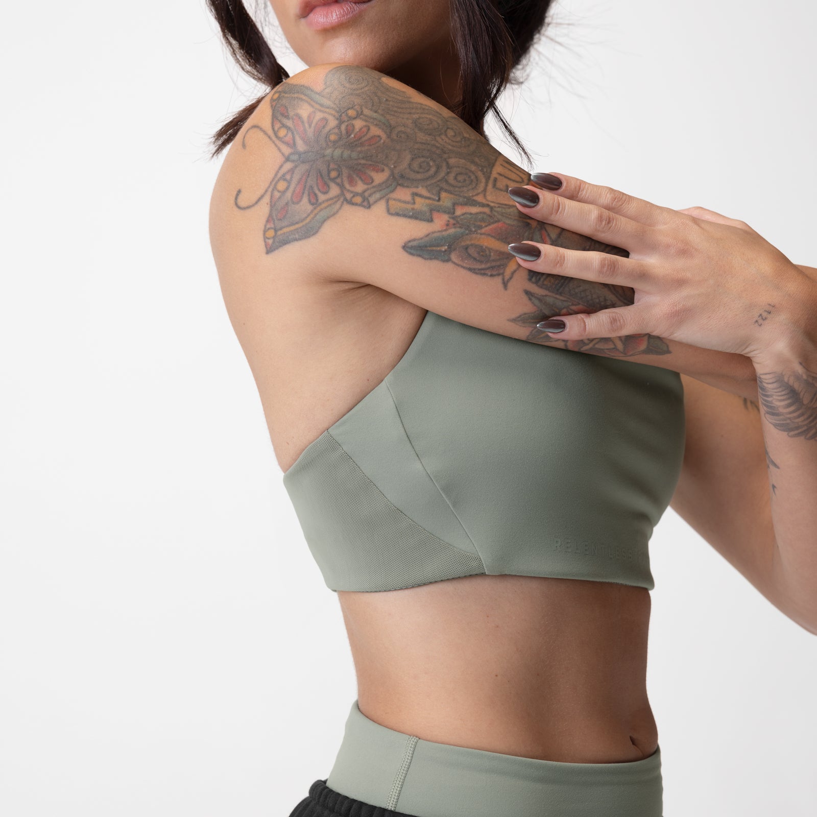 Sage Lycra® Hybrid Sports Bra worn by model showing back view with tattoos