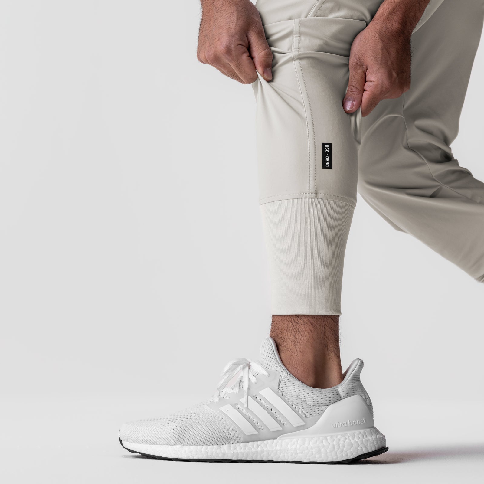 Tetra-Lite Tech High Rib Jogger in stone, worn with white sneakers, side view
