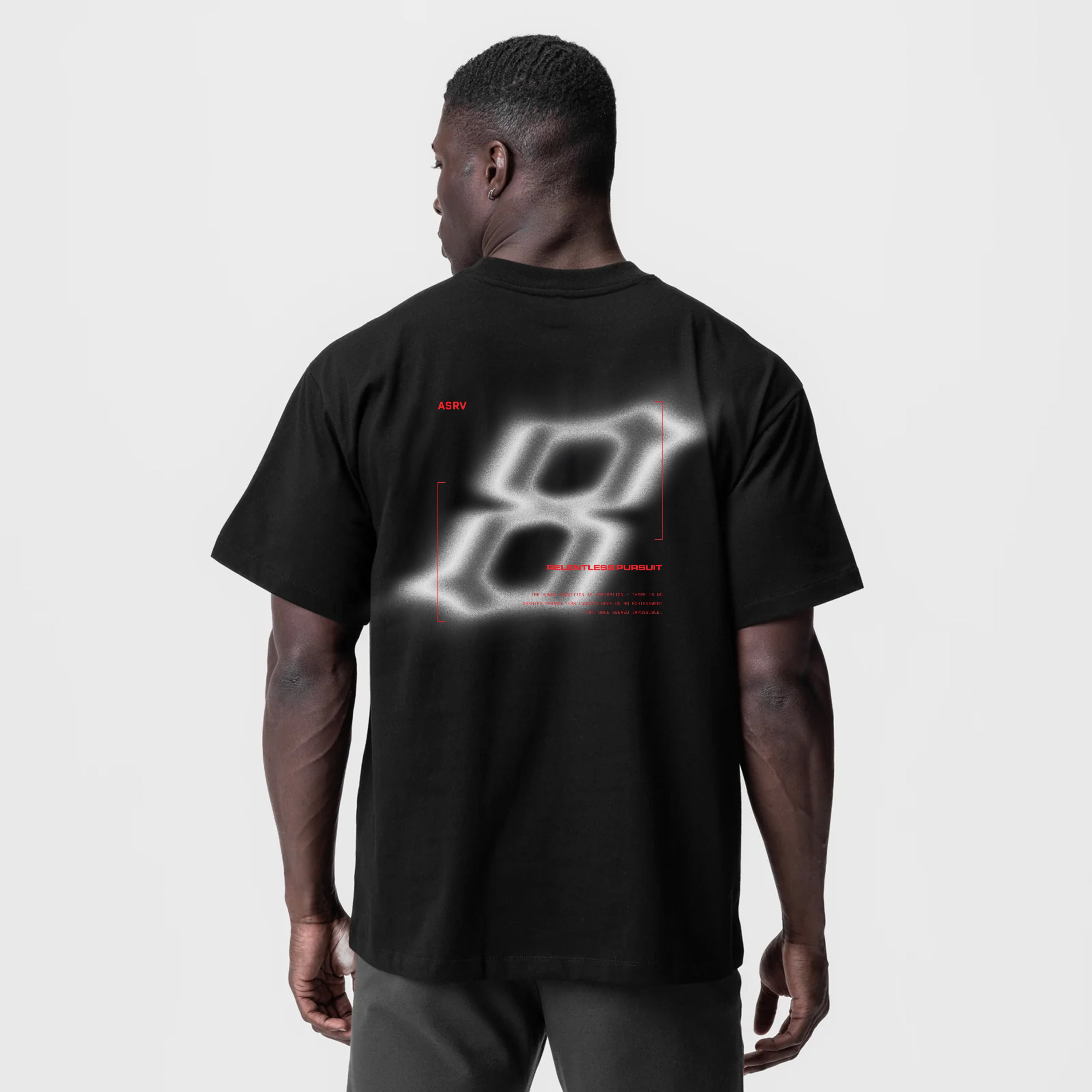 Black Tech Essential Relaxed Tee with blurred graphic design, back view on model