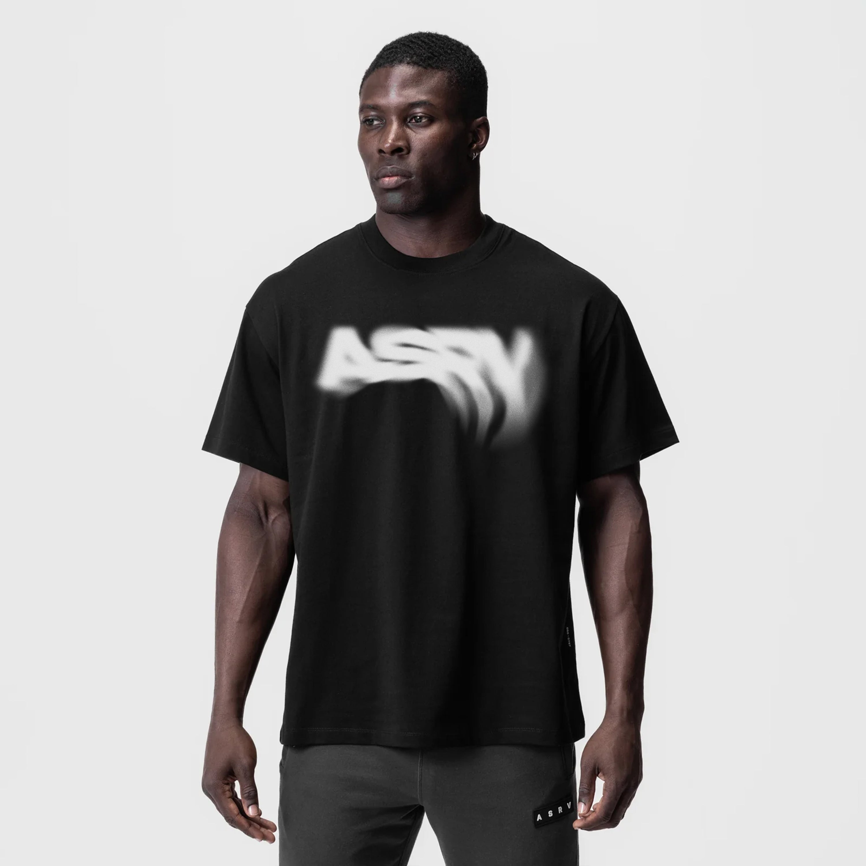 Black Tech Essential Relaxed Tee with 'Signal Lost' graphic, worn by model, front view